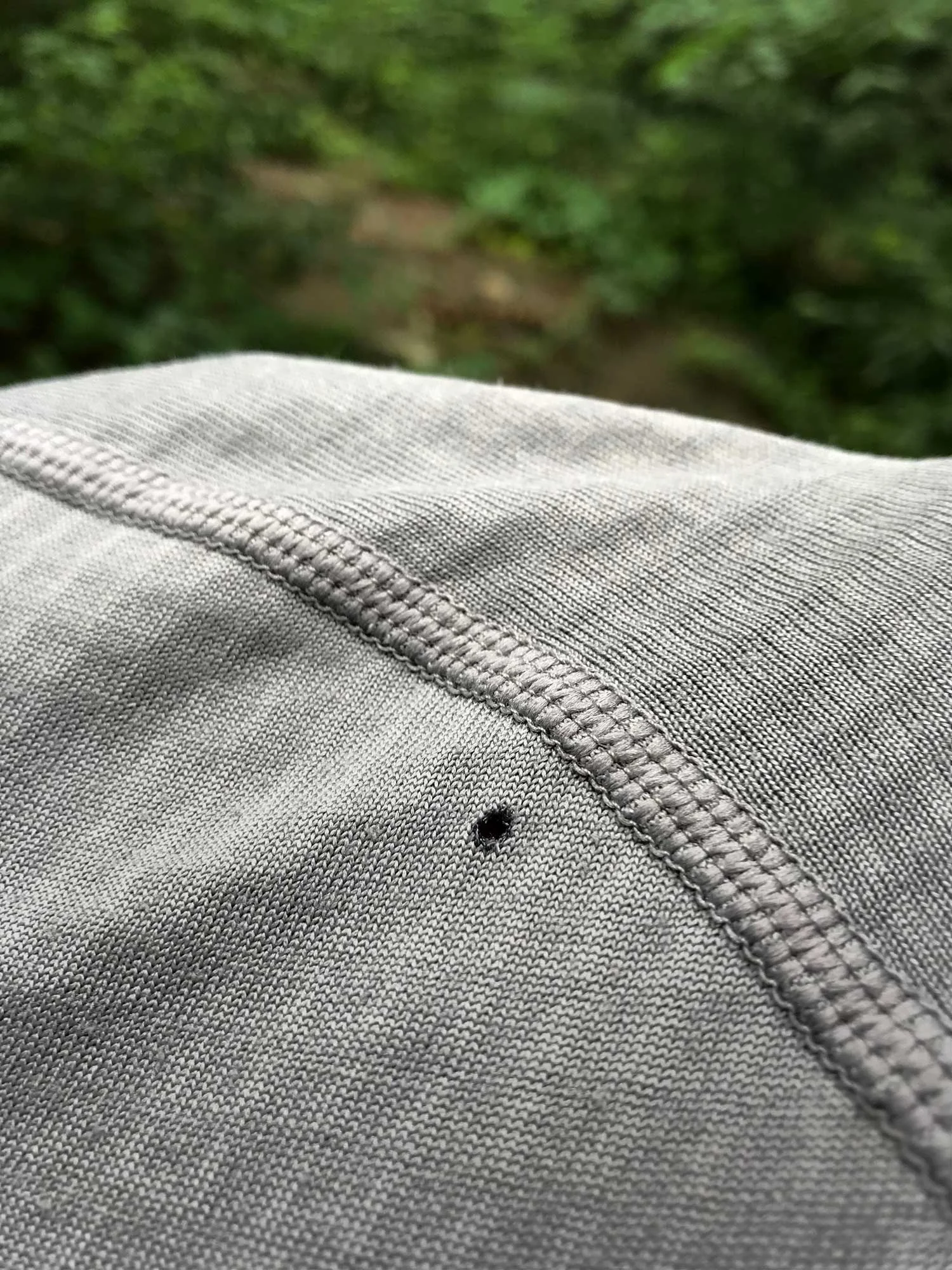 Polyester and camp fires don’t mix. One ember drifts onto you and you get a hole like this.