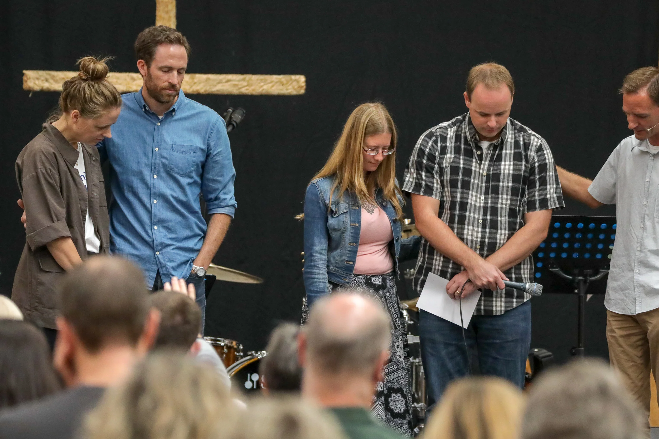 Reuben Munn praying with the Church Northwest team last Sunday.