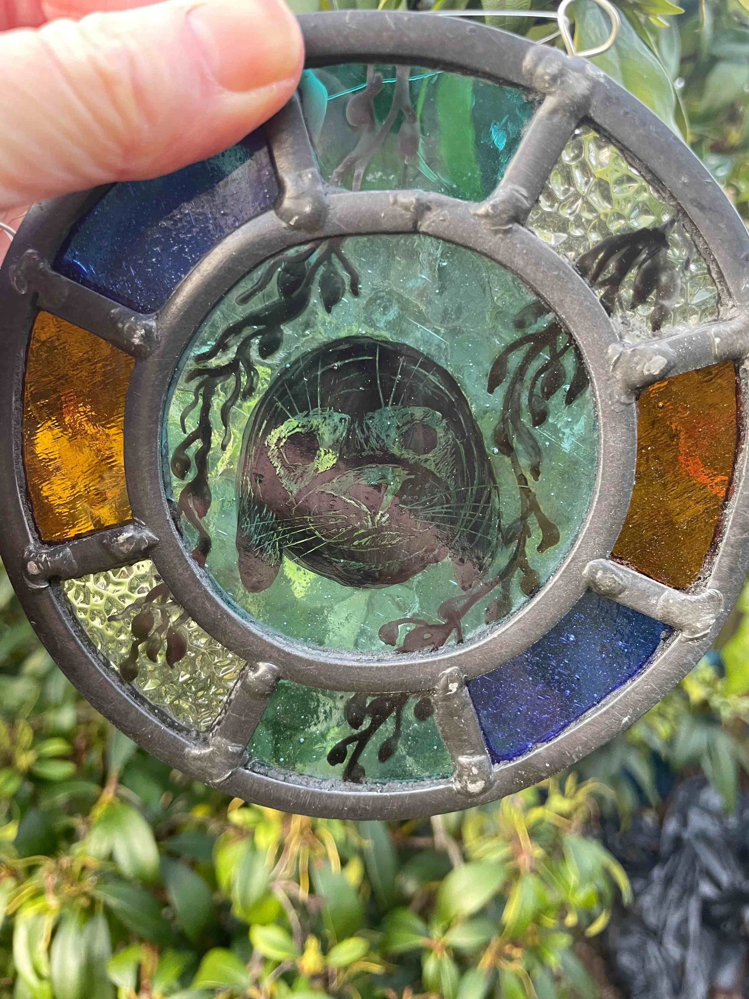 SMALL STAINED GLASS HANGING, SEAL FACE