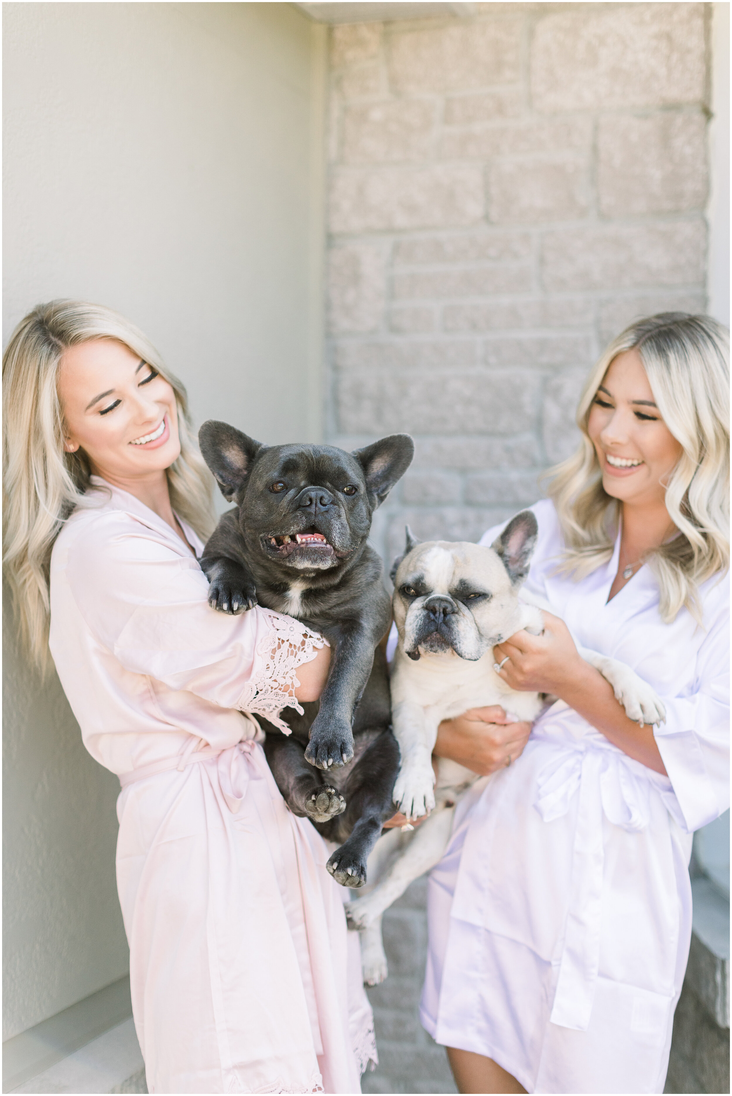  Bride and bridesmaid holding bulldogs in silk robes before the wedding ceremony in Ottawa, ON by Chelsea Mason Photography. dogs in wedding party dogs in wedding photos how to include dogs in wedding bridesmaid robes boho outdoor backyard wedding do