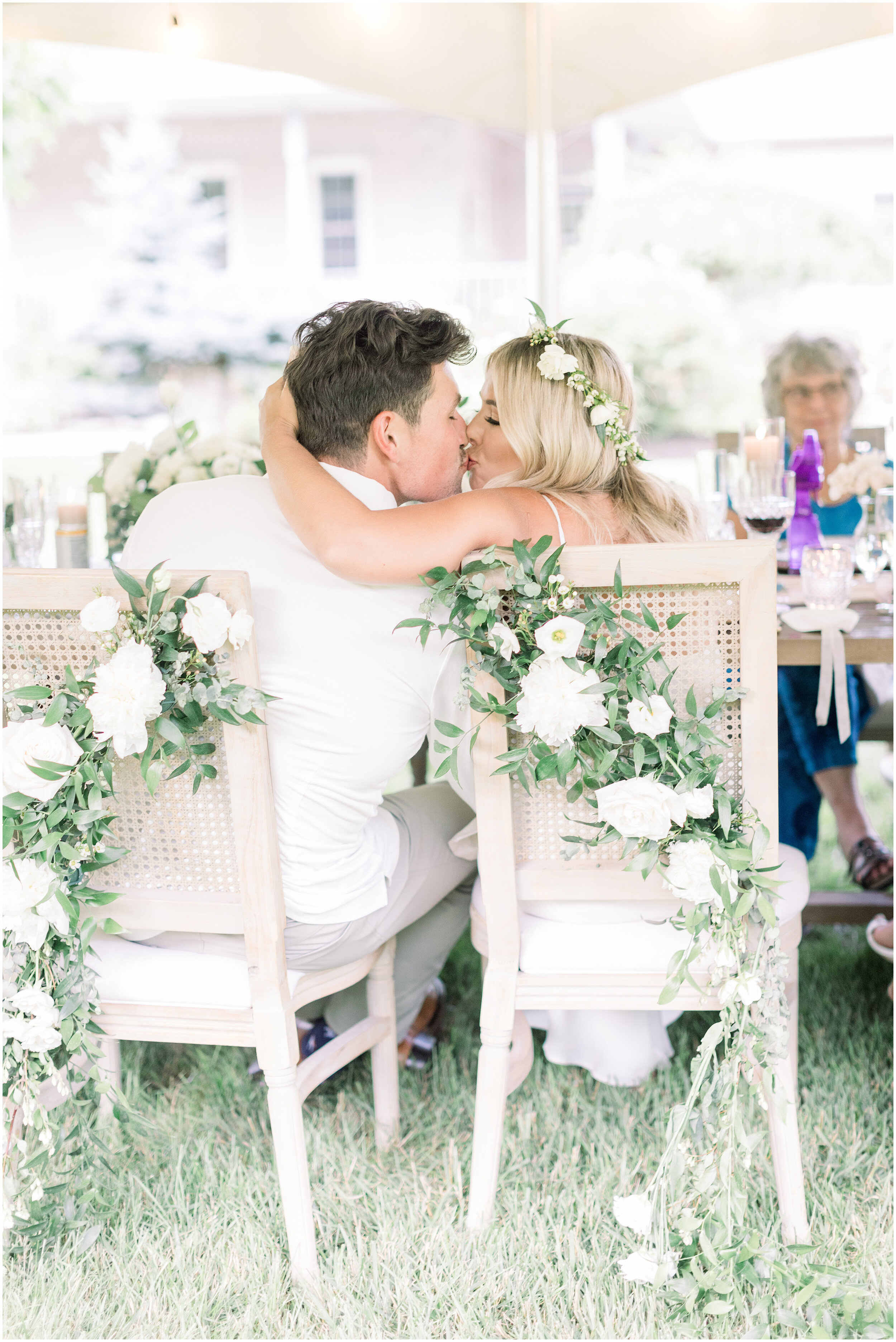  Beautiful outdoor wedding with flowers hanging on the back of chairs during the wedding dinner in Ottawa, ON by Chelsea Mason Photography. outdoor wedding decor simple backyard wedding decor white flower wedding decor seat decor for wedding how to d
