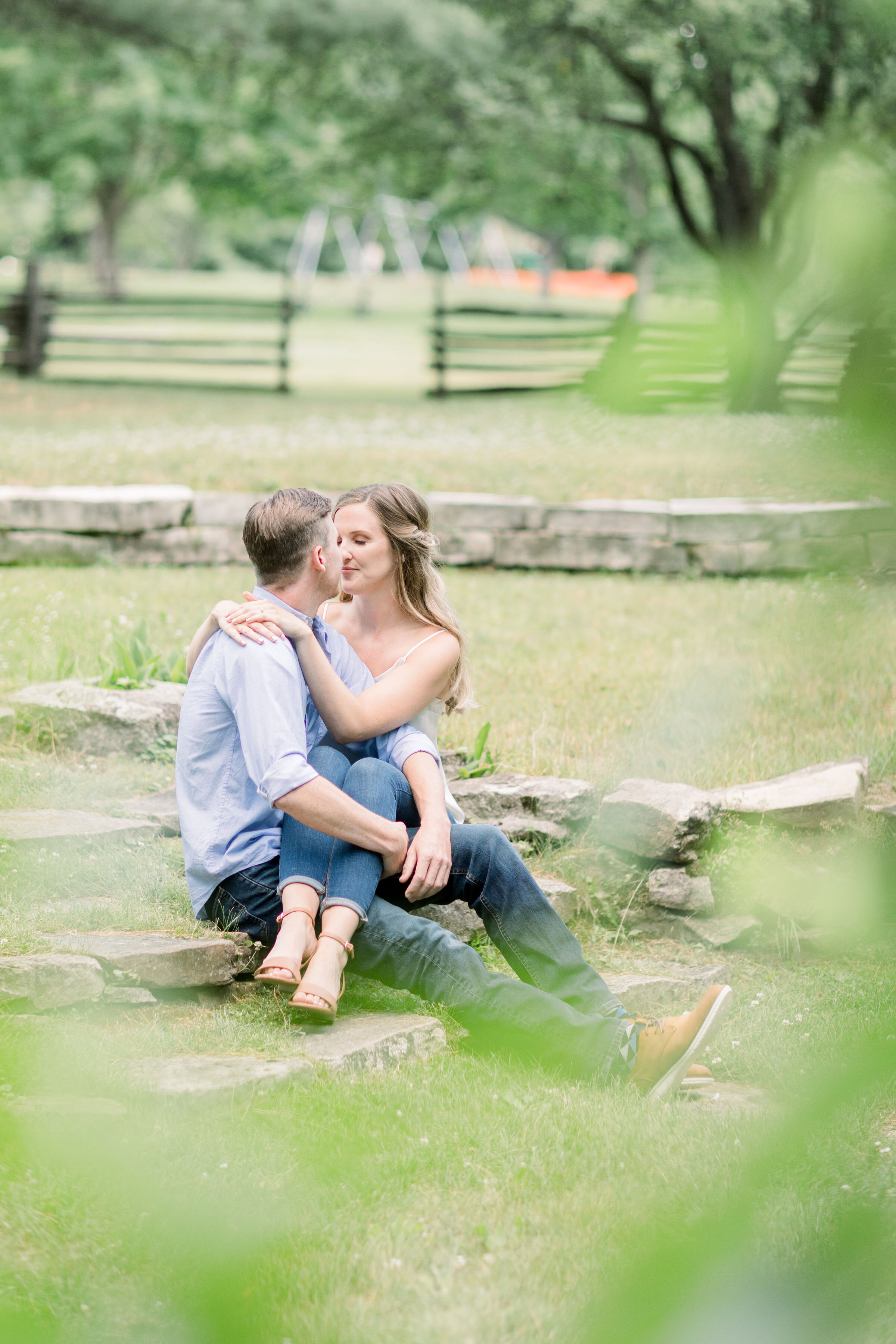  Intimate couple holding each other while sitting on the ground in this beautiful outdoor location in Ottawa, ON by Chelsea Mason Photography. couple poses for engagements couple poses intimate couple poses candid engagement photos kissing couple pho