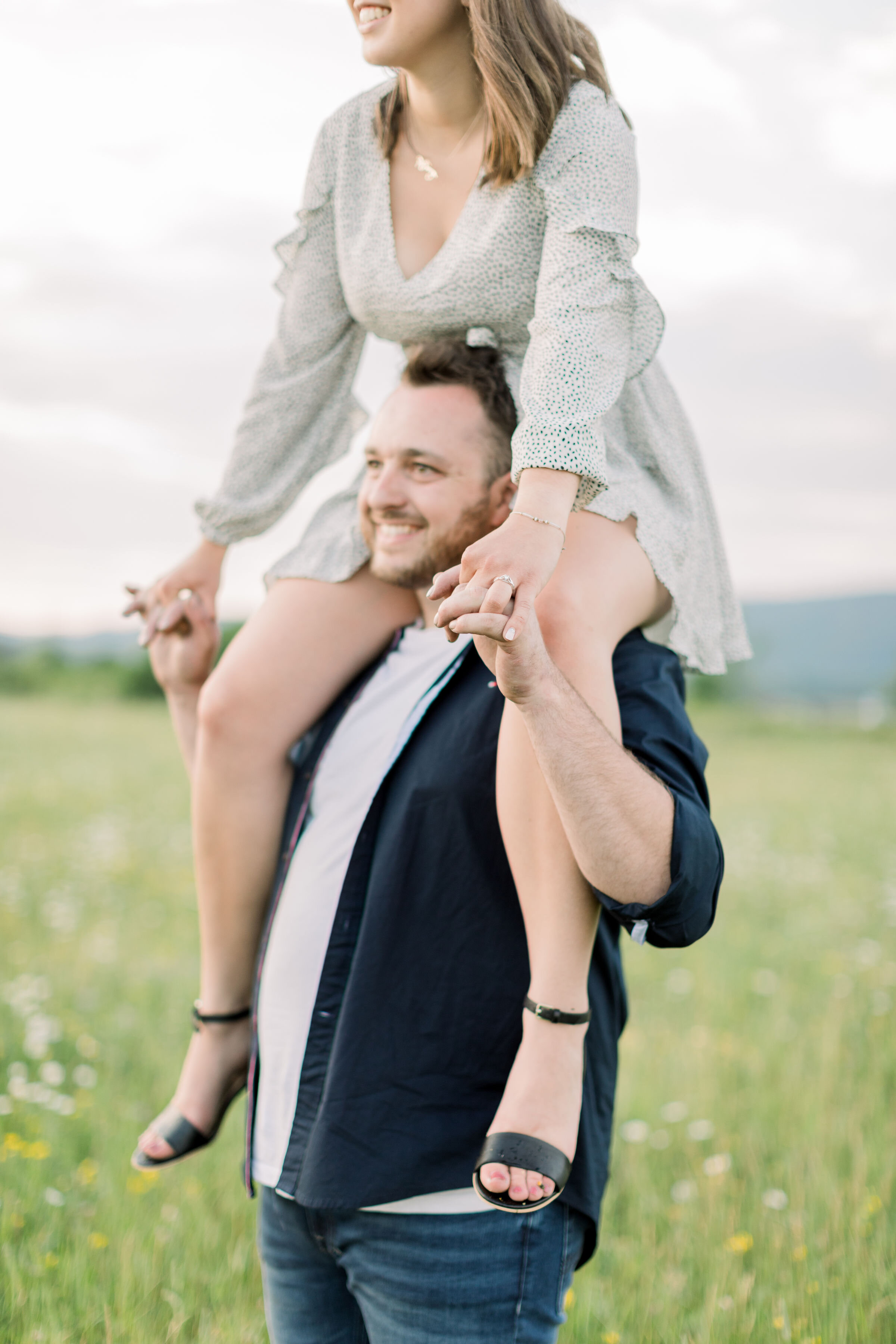  Close up shot of engagement couples spring outfit style with blue button-down and jeans and a short white and black dress with black pump sandals in Ottawa, ON by Chelsea Mason. spring photoshoot outfit inspo blue and white engagement photo colors o