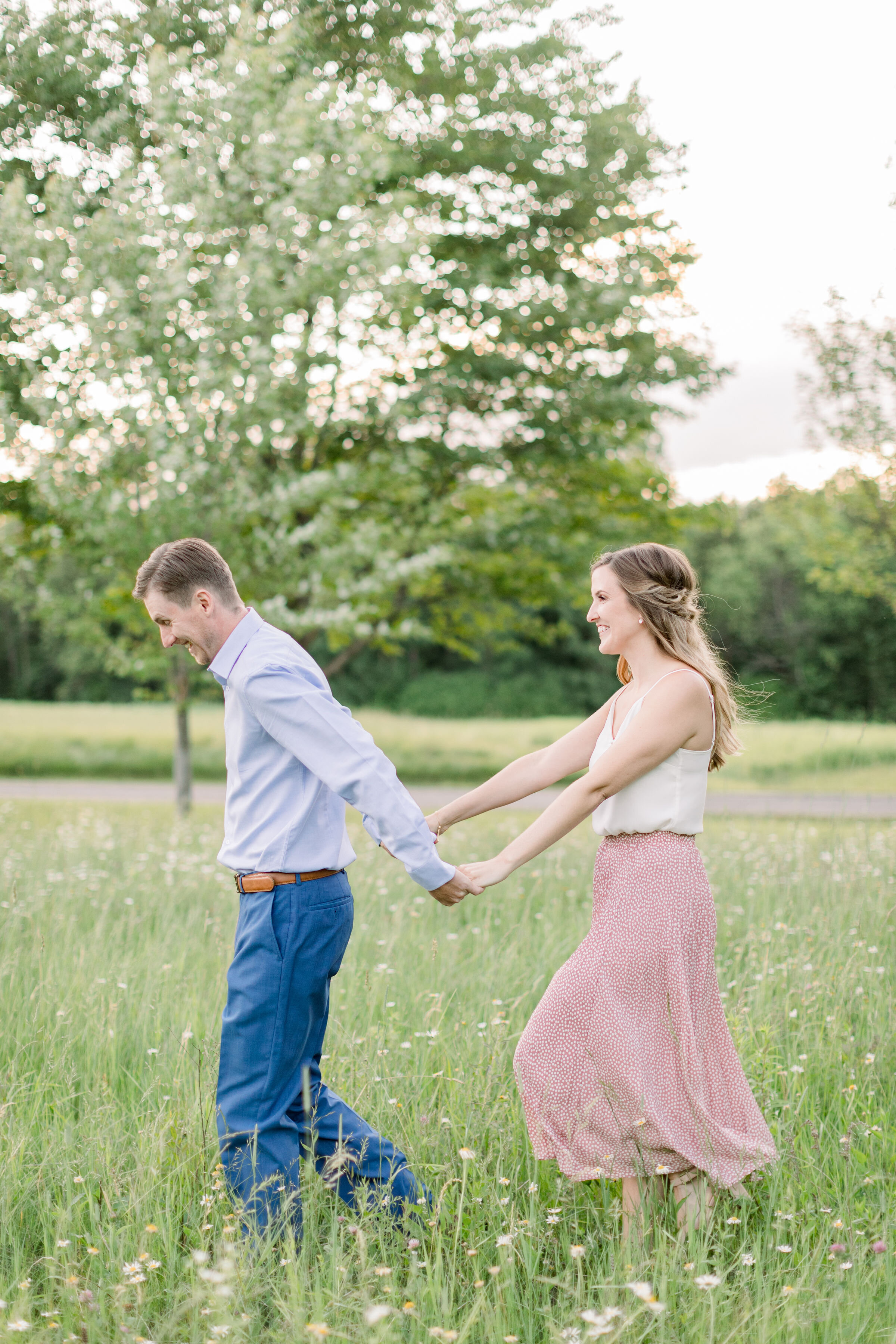  Perfect summer outfits for engagement photoshoot with blush calf-length skirt and white shirt and a blue shirt and pants in Ottawa, ON by Chelsea Mason Photography. pink and blue engagement colors engagement outfits inspo couple outfits summer engag