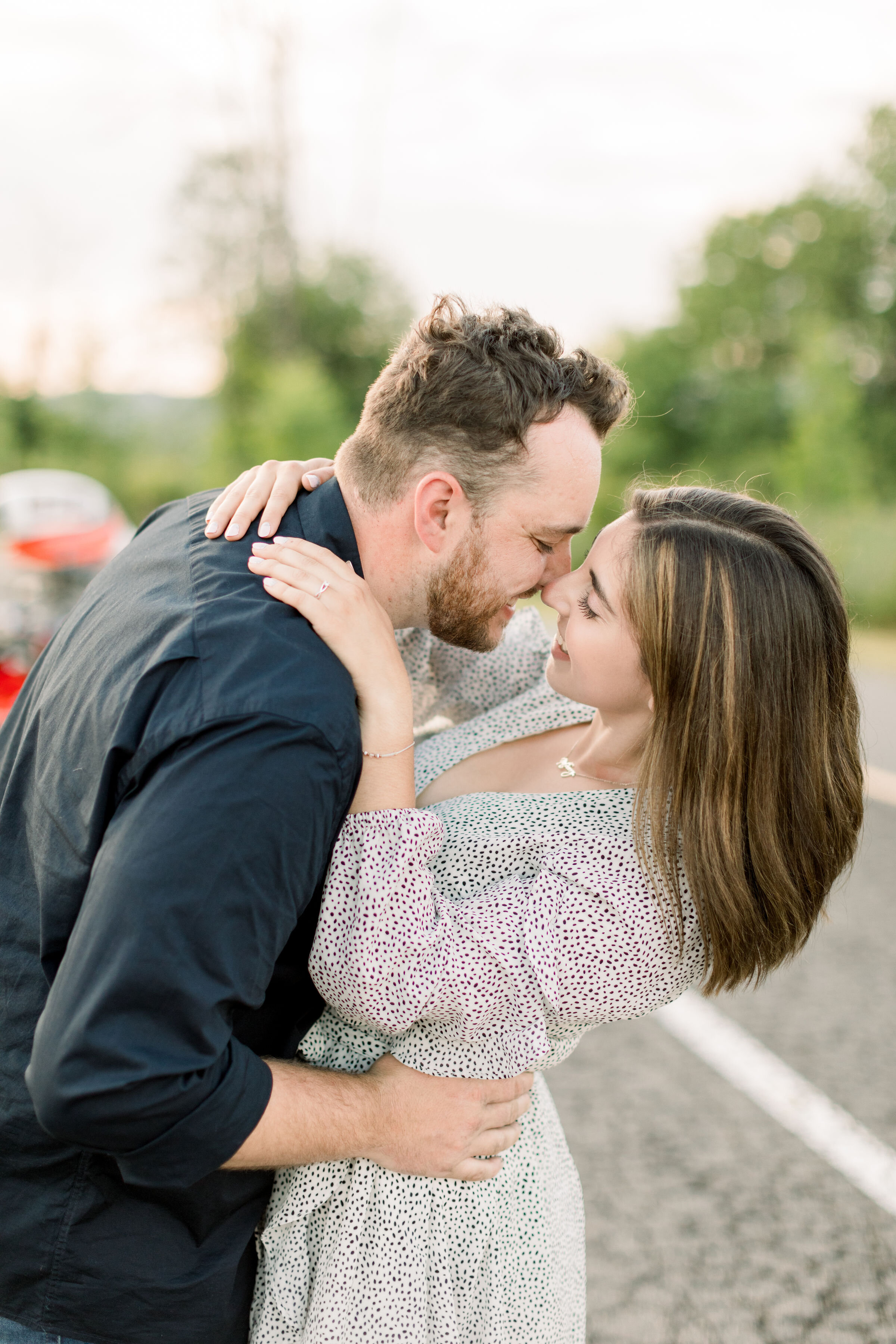 Close up shot of couple kissing on a road in their engagement photo session in Ottawa, ON by Chelsea Mason. kissing poses for couples engagement kissing poses how to photographer kissing photoshoots on road best photographer in ottawa perth kingston
