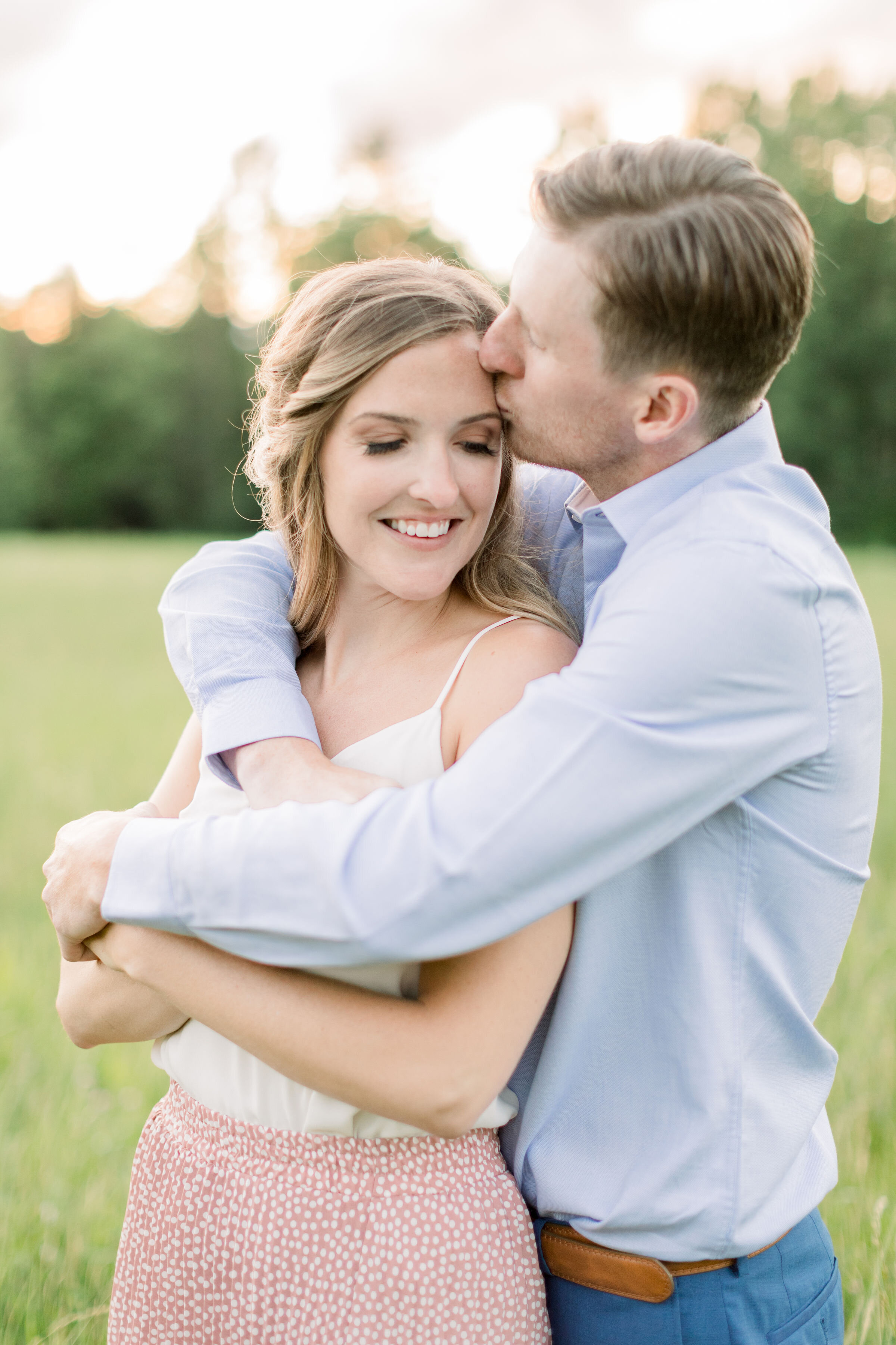  Adorable couple in engagement photoshoot wearing summer styled clothes with white and pink and blue by Chelsea Mason Photography in Ottawa, ON. summer styled photoshoots outfits for summer photoshoots engagement outfit inspo colors to wear for summe
