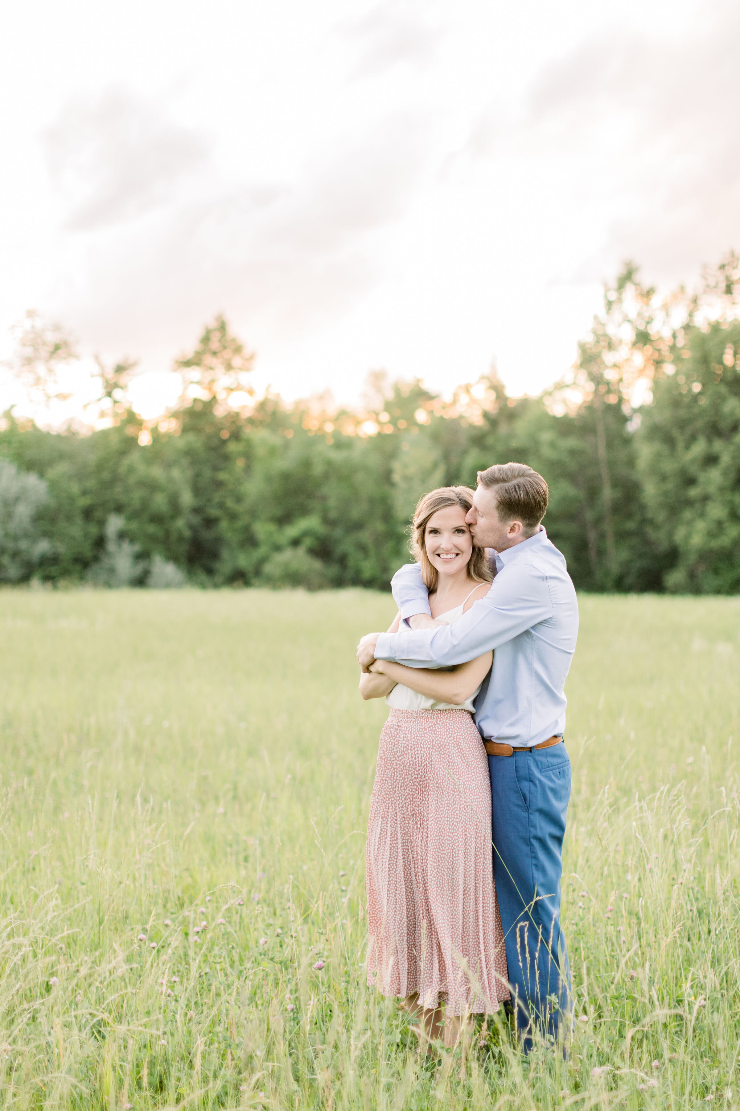  Perfect outdoor location for engagement photo shoot with grass field and treelined horizon in Ottawa, ON by Chelsea Mason Photograpy. tree lined horizon grass fields outdoor wedding photoshoots engagements outdoors in ottawa summer engagement photos