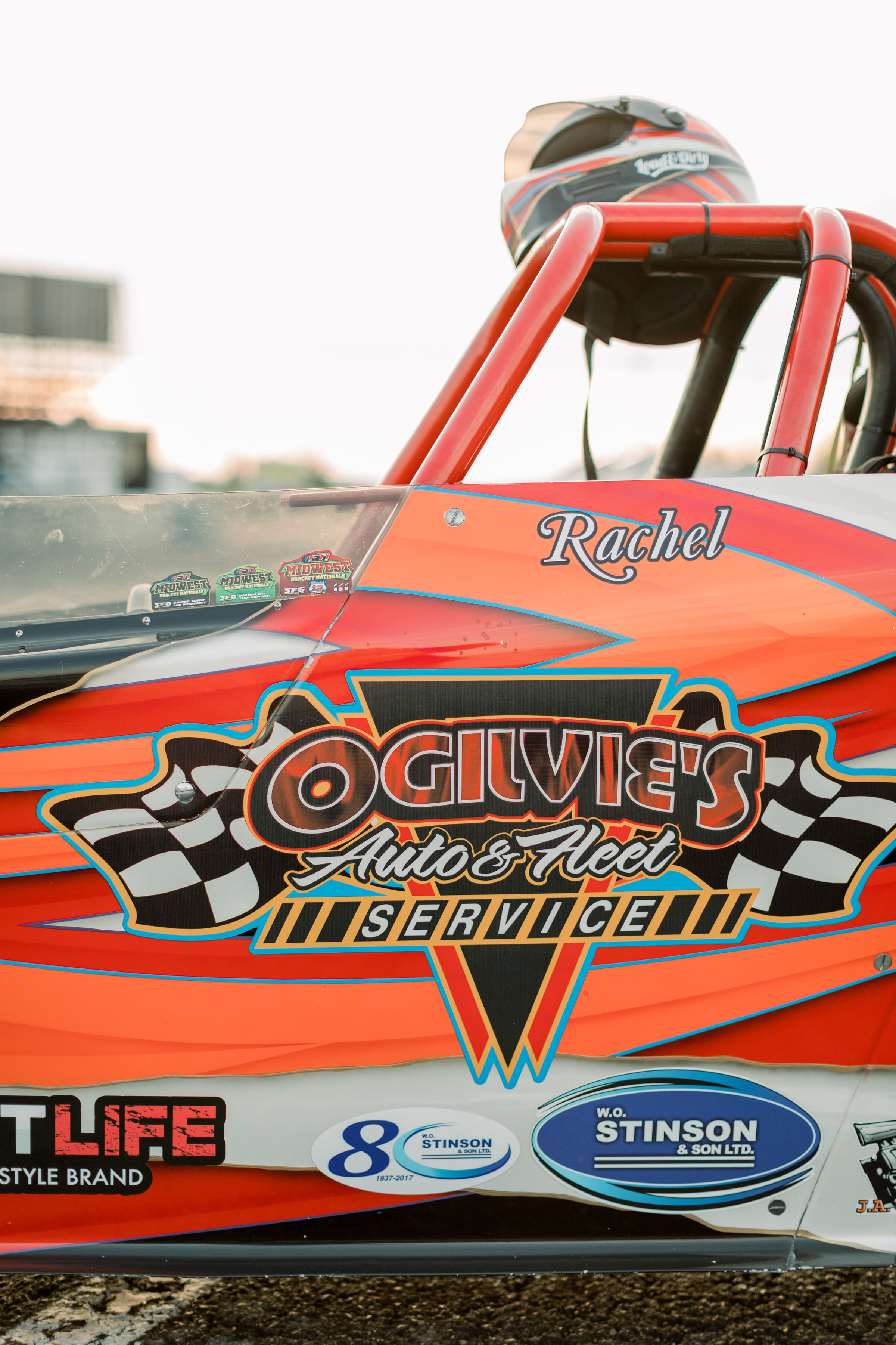  Racecar detail shot with brides name on it by O'gilvies Auto and Fleet Service during an engagement session by Chelsea Mason in Ottawa, ON. perth kingston carleton place best wedding photographer in ottawa details shots for engagements cars in photo