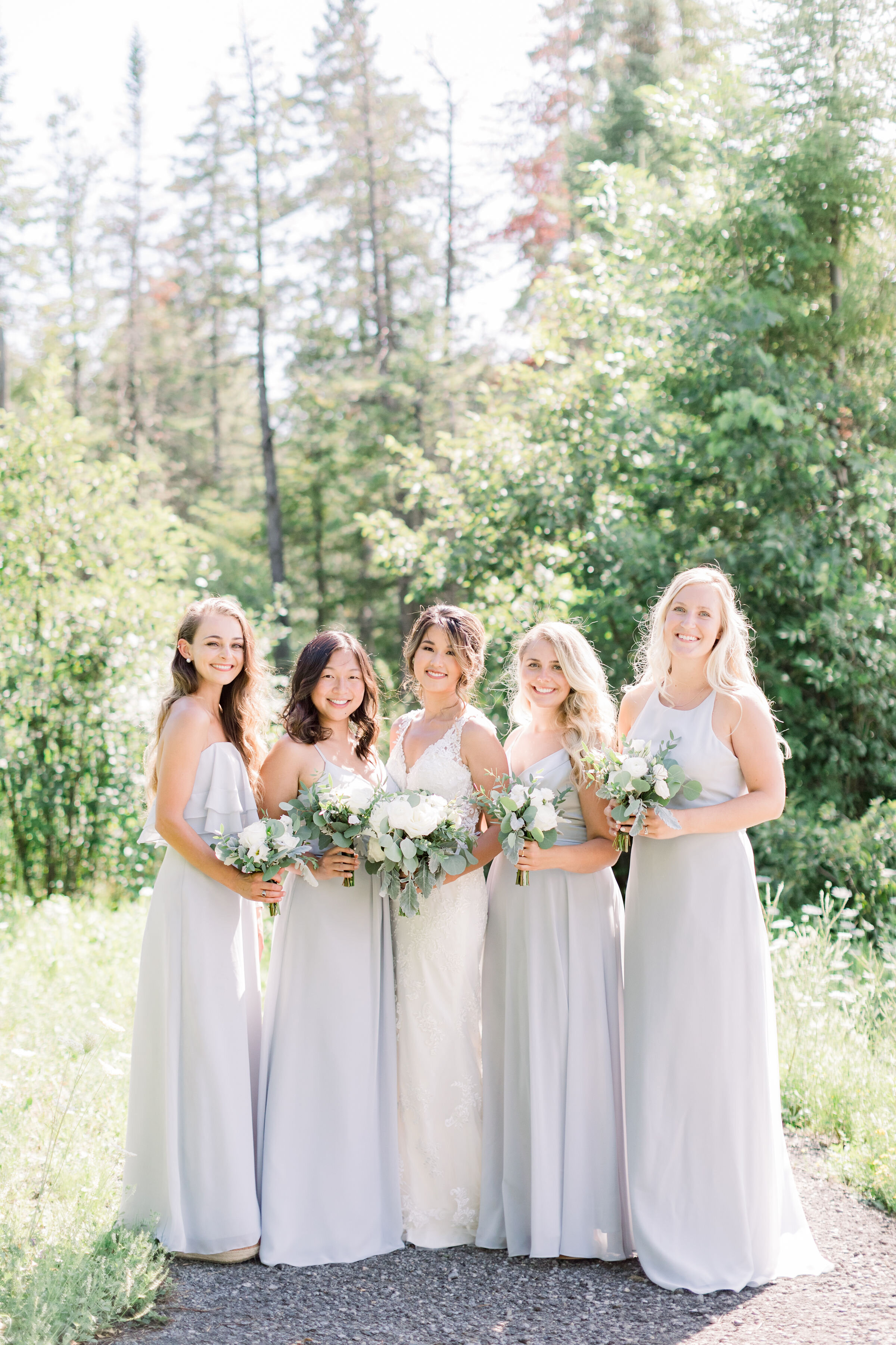  Beautiful bridesmaids in matching silver or gray wedding dresses with white flower bouquet by Chelsea Mason Photography in Ottawa, ON. bridesmaid outfits dresses for bridesmaid gray wedding colors neutral wedding colors white and silver wedding colo
