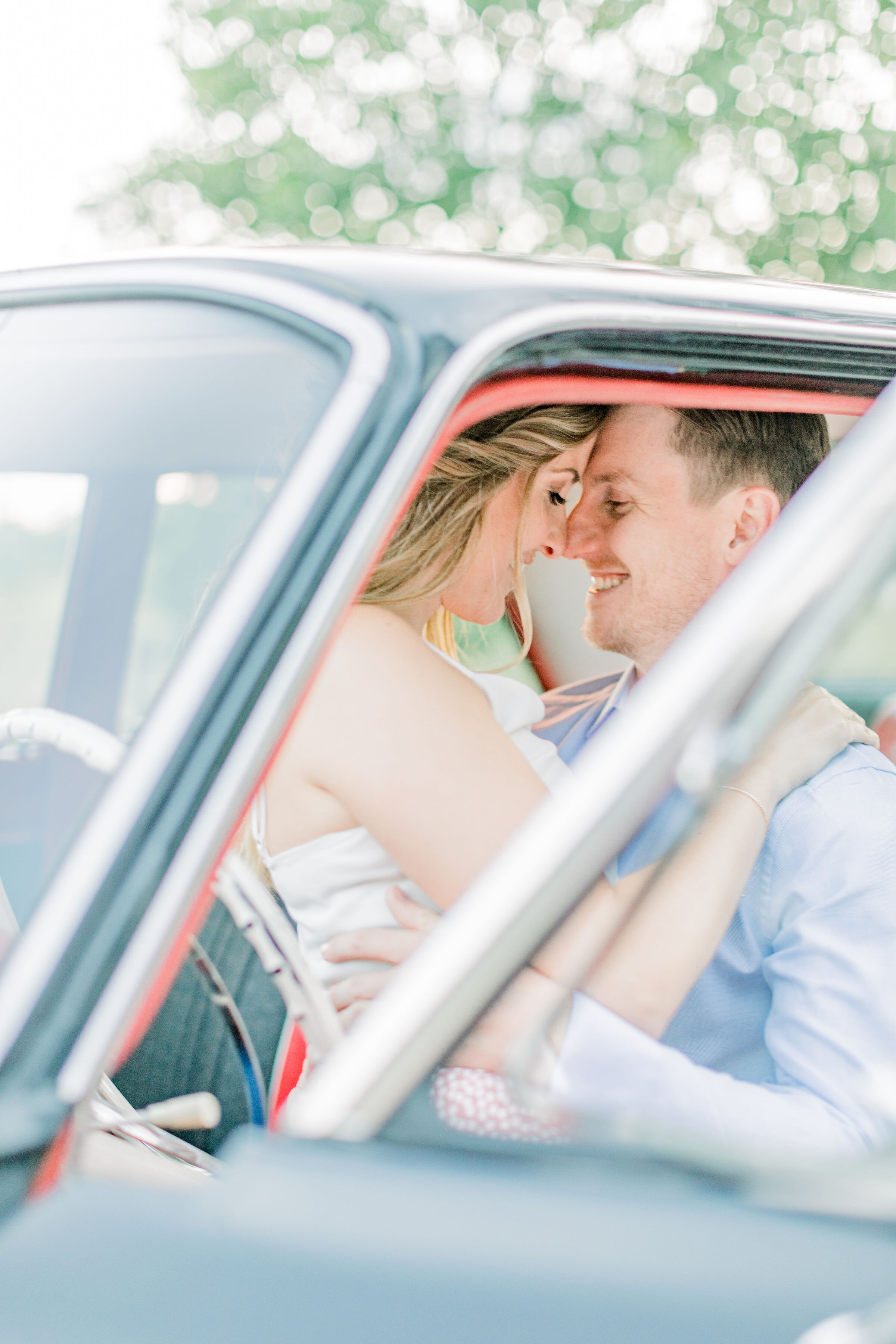  Intimate shot of couple in a vintage and classic car during their engagement photoshoot in Ottawa, ON by Chelsea Mason Photography. fun poses for couples fun engagements photos props for engagement photos how to shoot engagements in a car intimate p