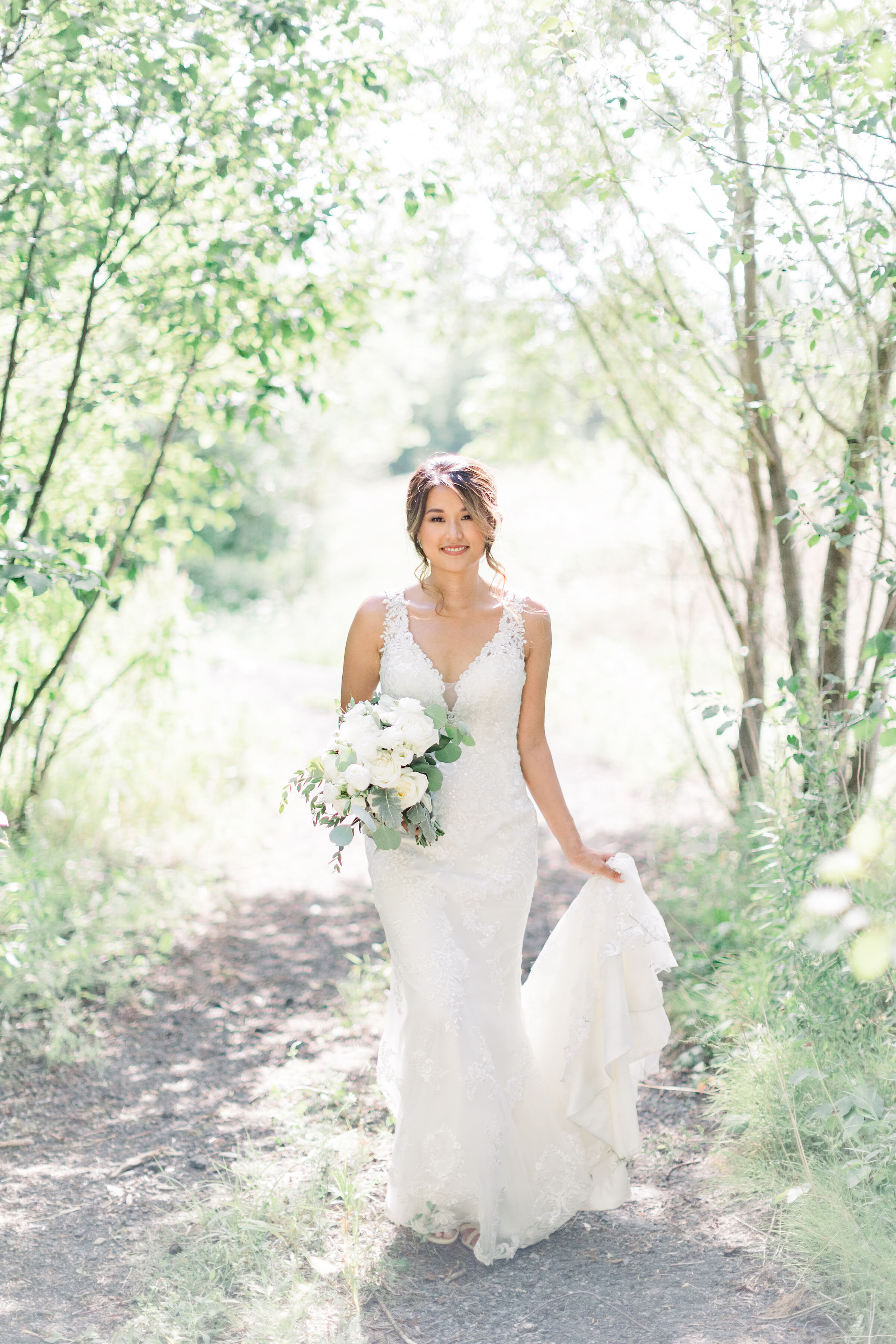  Beautiful bride with plunging neckline white lace dress and long train with white wedding bouquet in Ottawa, ON by Chelsea Mason Photography. vneck wedding dress low cut wedding dress plunging neckline wedding dress lace wedding dress lace wedding t