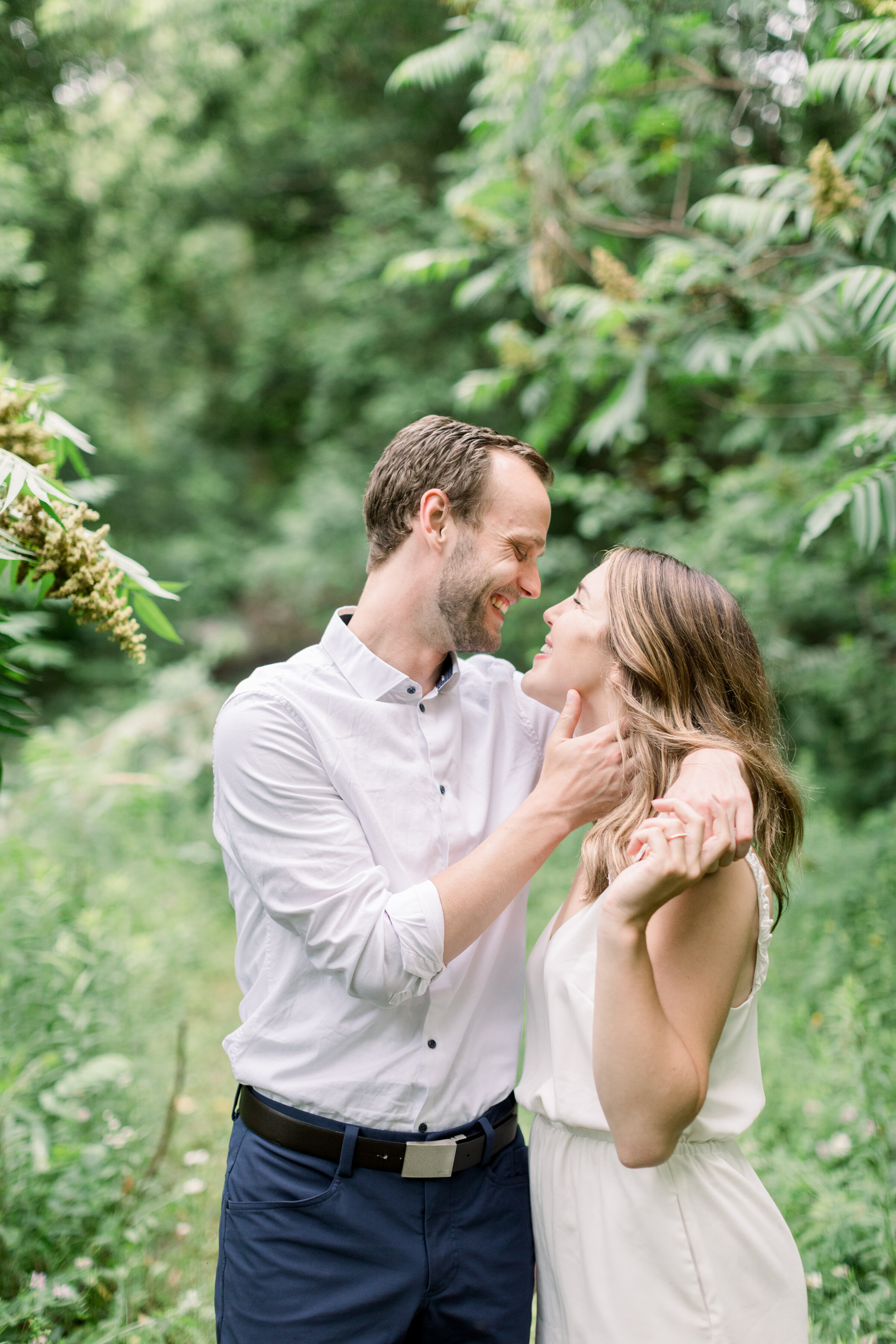  Beautiful couple wearing all white in engagement photos for a summer photoshoot in Ottawa, ON by Chelsea Mason Photography. outdoor weddings best locations for outdoor photoshoot in kingston summer engagement photoshoots outfit inspo for engagements