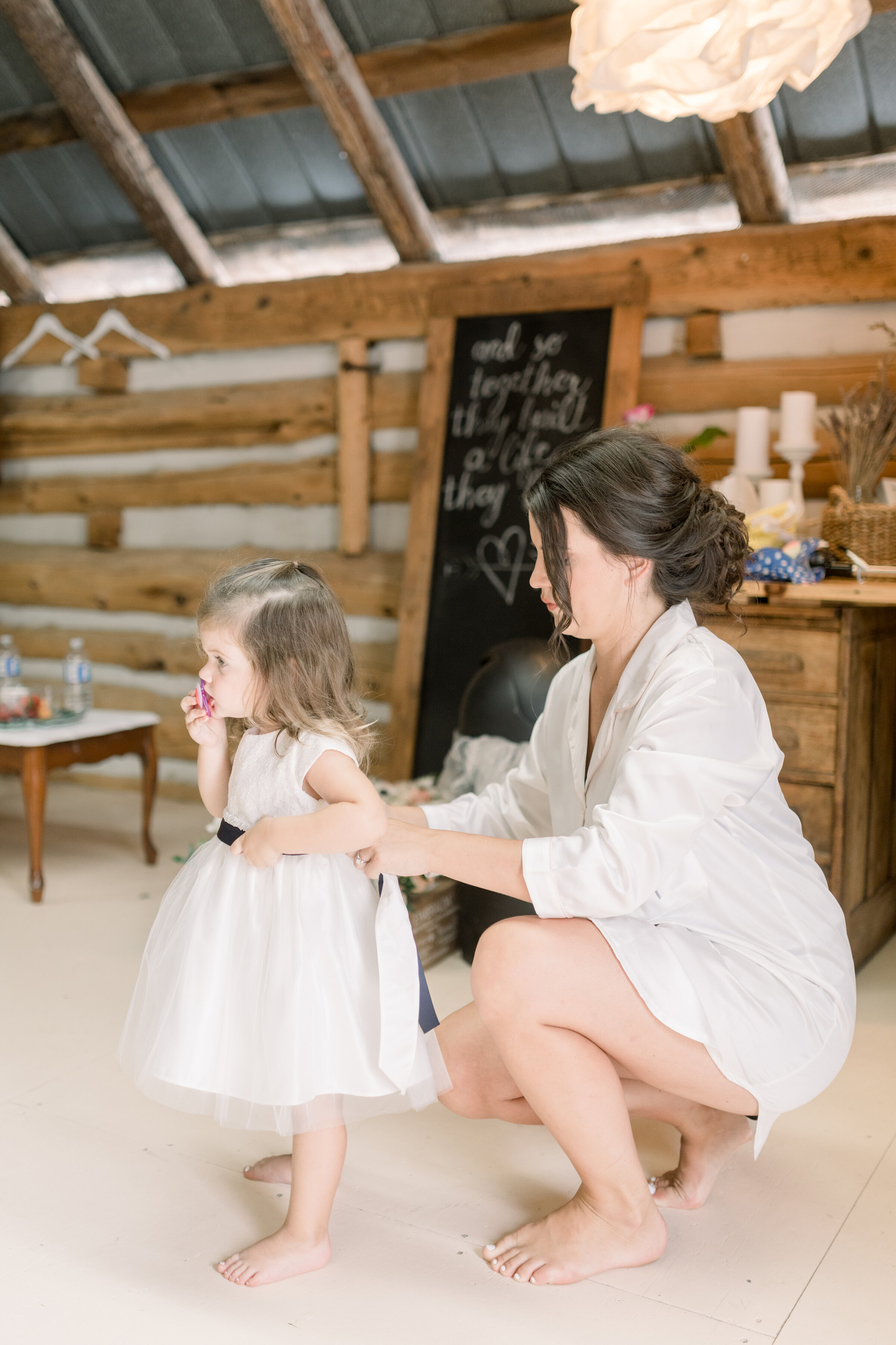  Adorable flower girl dress that is white with a blue ribbon for outfit inspo by Chelsea Mason Photography in Ottawa, ON. the herb garden wedding venue flower girl outfit inspo how to dress your flower girl how old should your flower girl be how to d