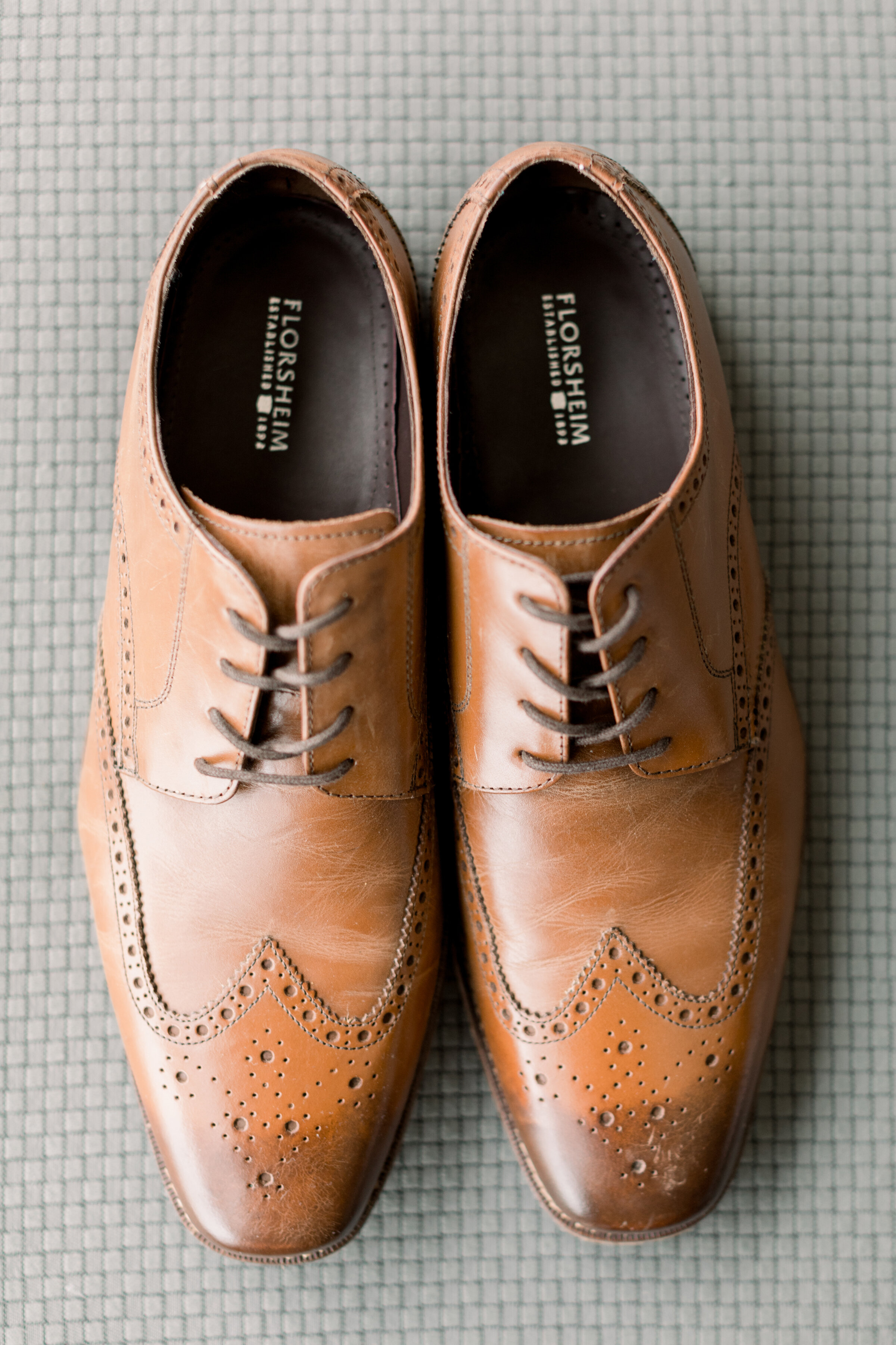  Detail shot of grooms classic cognac brown wedding shoes at The Herb Garden by Chelsea Mason Photography. ottawa on photography how to dress our groom outfit inspo for groom dressing your groom for your wedding brown shoes for groom best colors for 