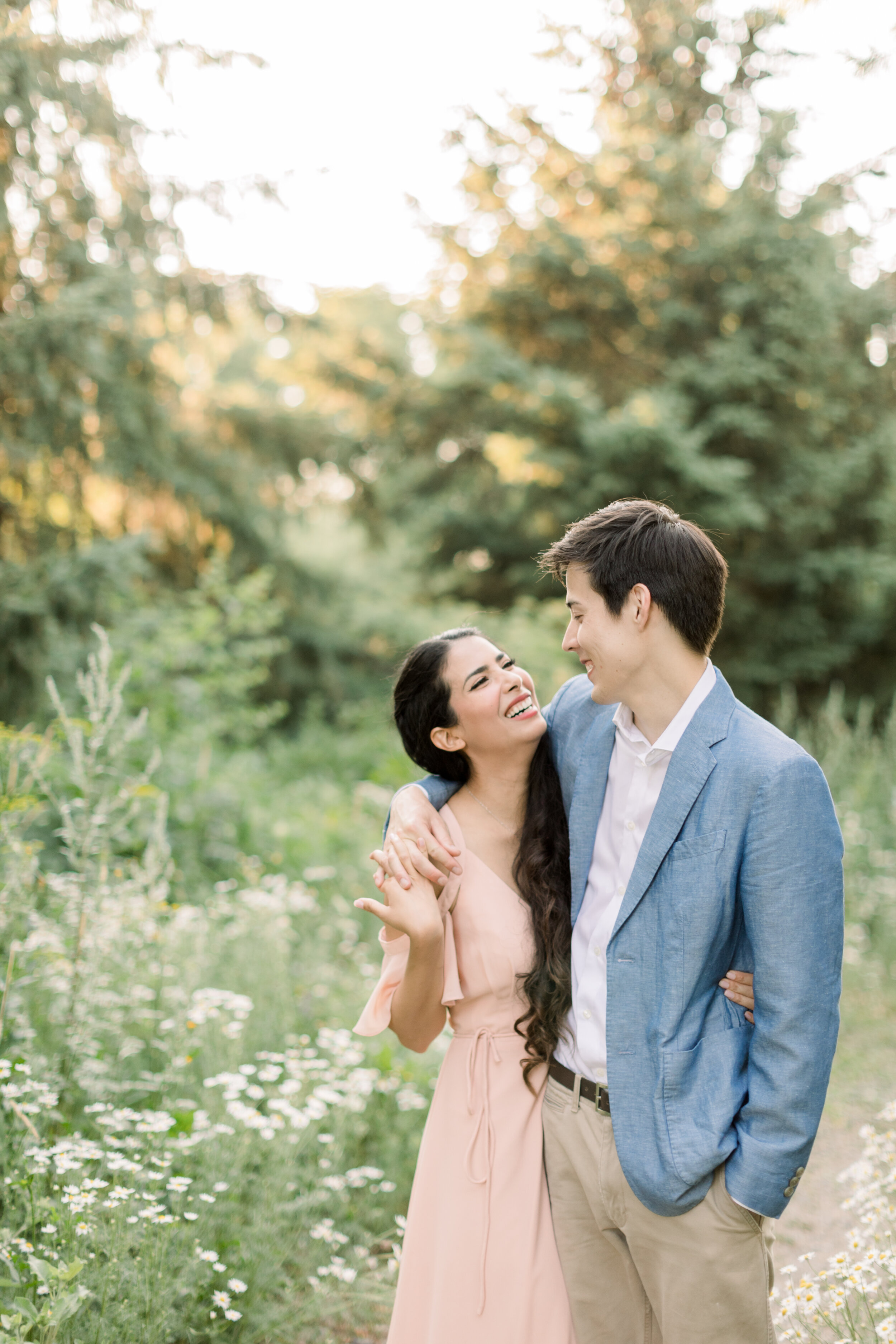  Perfect couple for a summer engagement photo session styled in a pink dress with a light blue blazer by Chelsea Mason Photography in Ottawa, ON. how to dress for engagements colors for engagements summer outfit inspo for engagements dressing him for