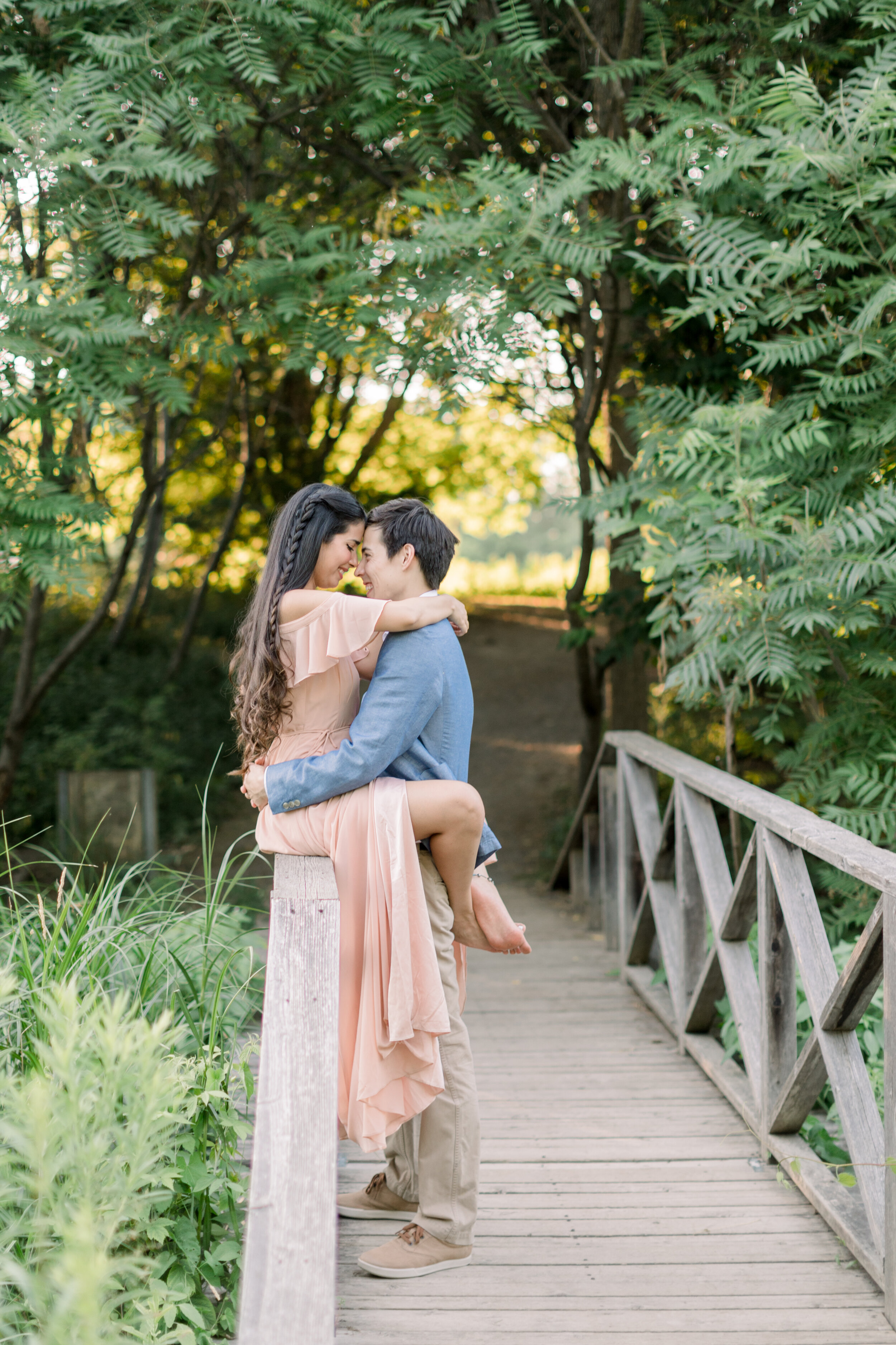  Beautiful couple posing for engagements on a pretty bridge at the arboretum in Ottawa, ON by Chelsea Mason Photography. locations with bridges for photoshoots in ottawa brides for engagements in kingston best engagement locations in ottawa best wedd