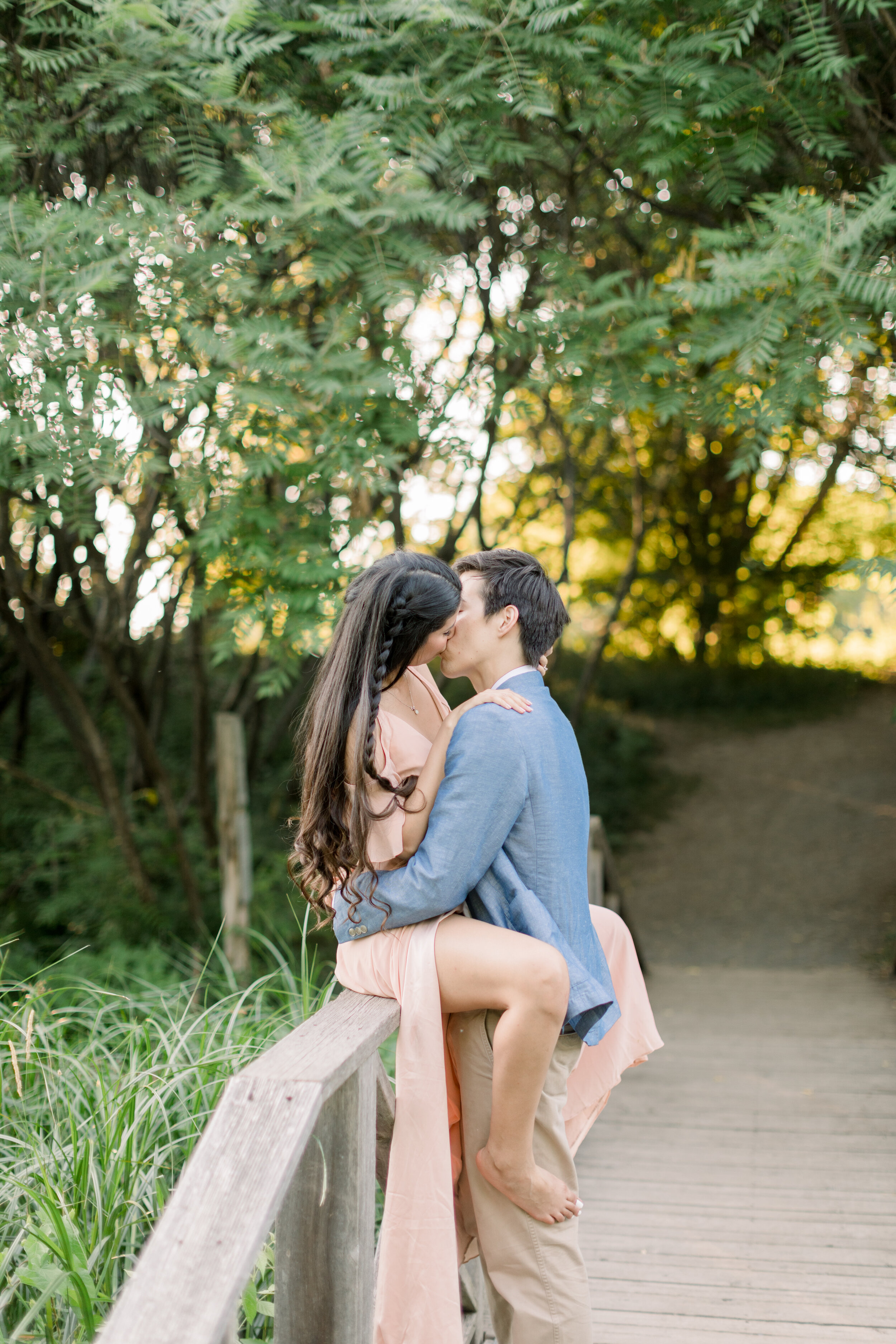  Couple kissing intimately on a bridge in this ideal outdoor photoshoot location in Ottawa, ON by Chelsea Mason Photography. how to style couples for engagements intimate poses for couples poses for couples photoshoots for couples engagement poses id