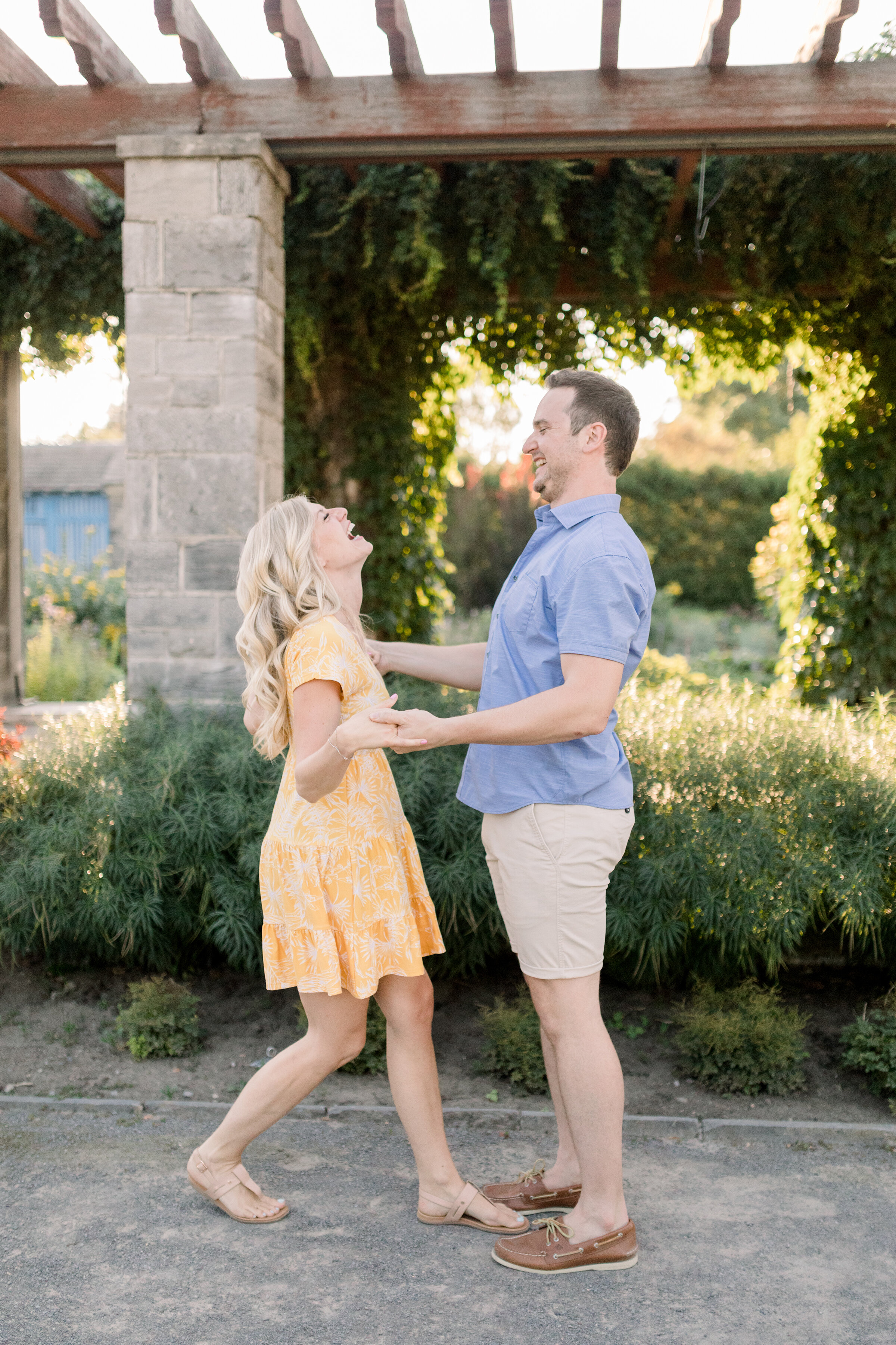  A gorgeous couple laugh together under a beautiful terrace in engagement styled photo shoot by Chelsea Mason Photography. Engagement session inspiration ideas and goals client attire inspiration for women  couple goals engagement location inspiratio