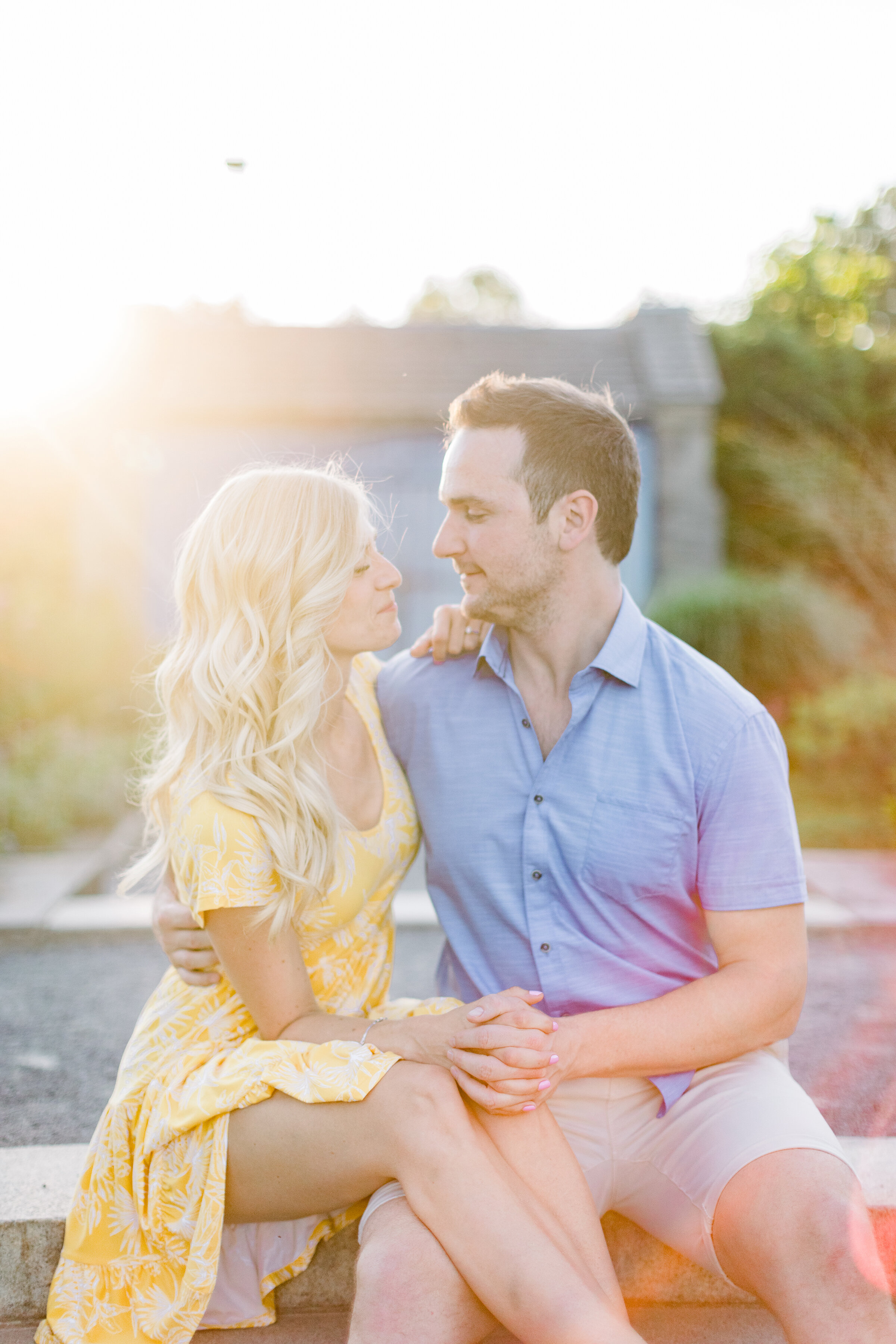  A beautiful couple sit together as the sun streams in in a beautiful engagement styled photo shoot in Montreal, Canada. Couple sitting pose inspiration sundress inspiration men’s attire inspiration client attire inspiration Chelsea Mason Photography