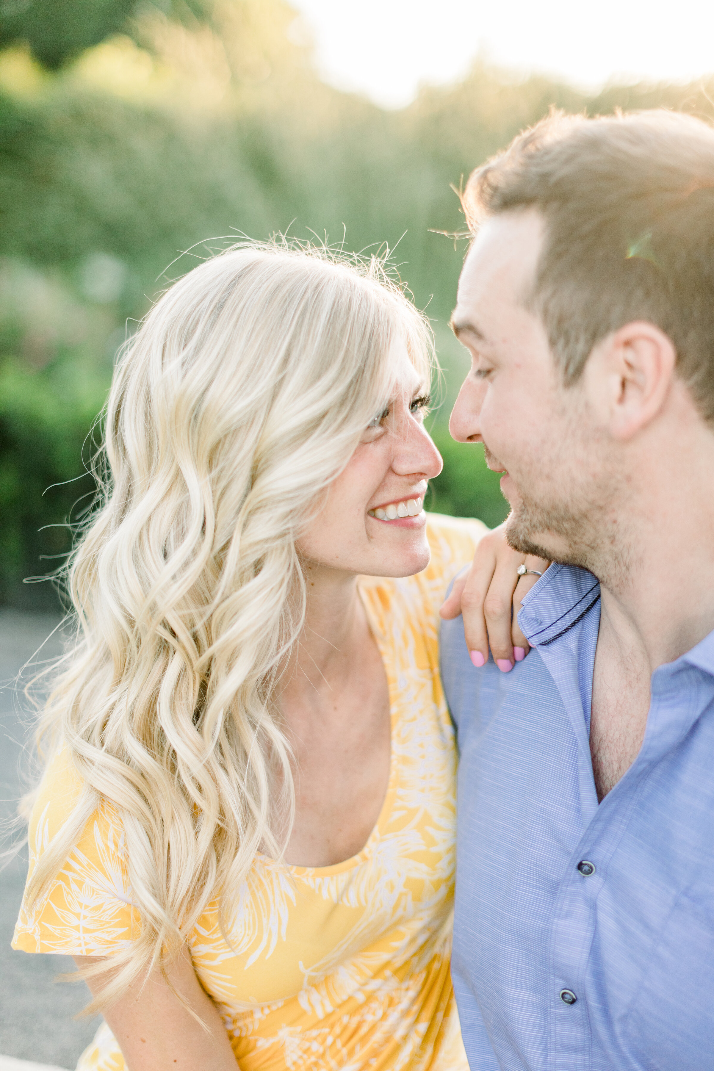  A glowing couple gaze into each others eyes in a romantic engagement session by Chelsea Mason Photography. Couple sitting pose inspiration ideas and goals professional photographer engagement session inspiration Botanical Garden Montreal Canada outd