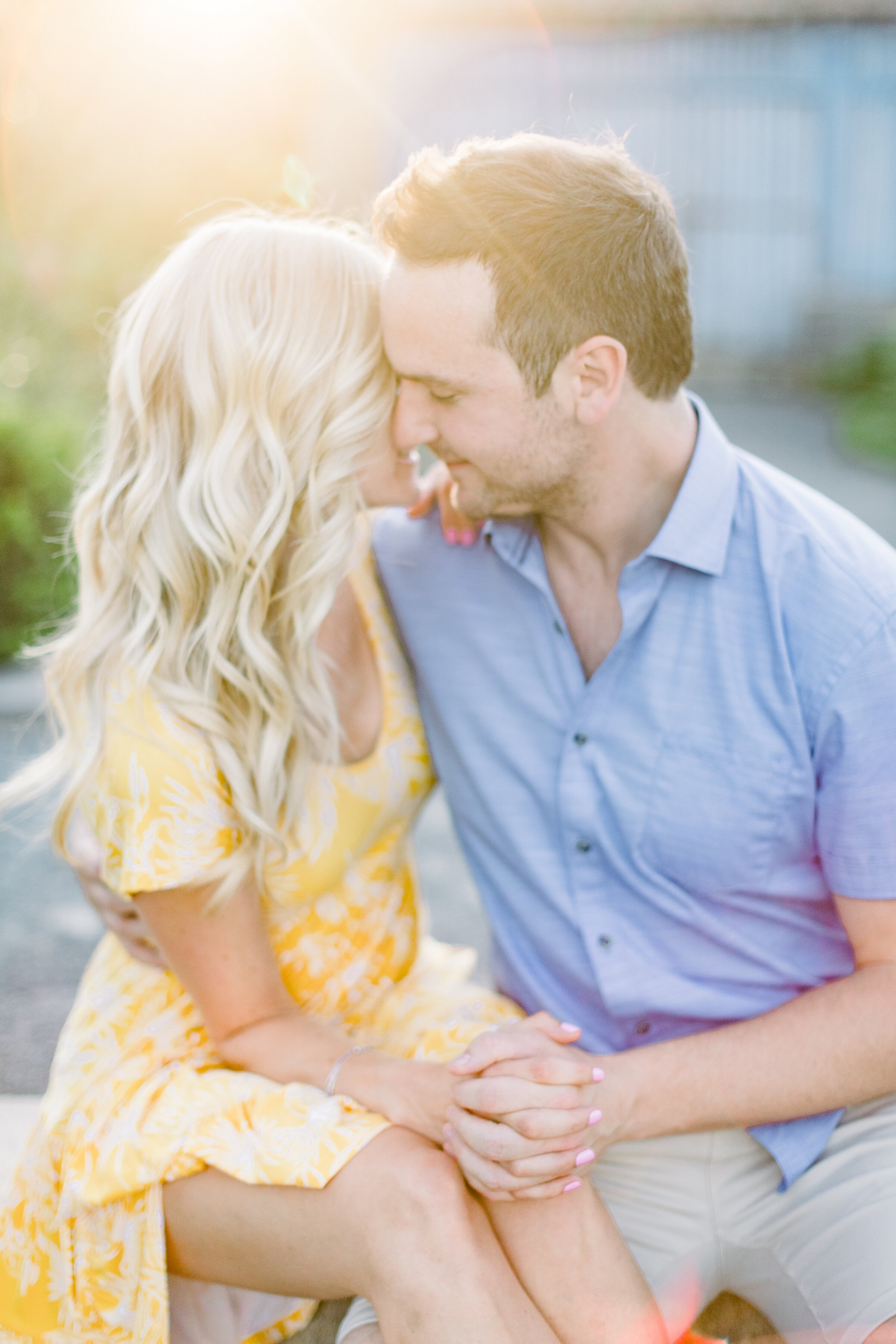  A beautiful couple sit together in the sun on a gorgeous engagement styled photo shoot by Chelsea Mason Photography in Montreal Canada. Spring dress inspiration for engagement sessions men’s outfit inspiration sun dress inspiration yellow flowy dres