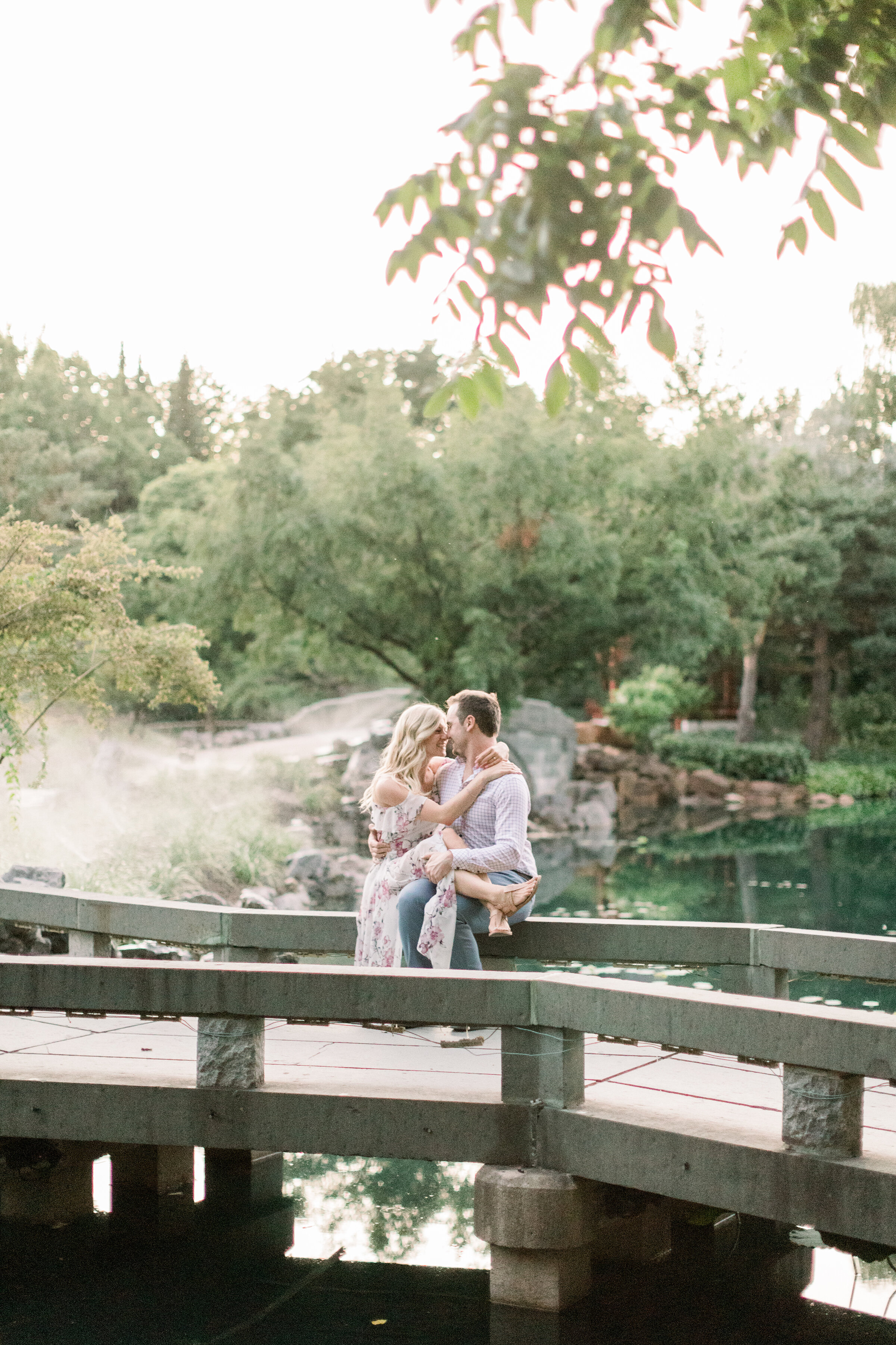  A beautiful couple kiss on the bridge in Montreal’s Botanical Garden in engagement styled photo shoot by Chelsea Mason Photography. Couple goals couple pose inspiration photo shoot location inspiration in Canada kissing pose inspiration  outdoor pho