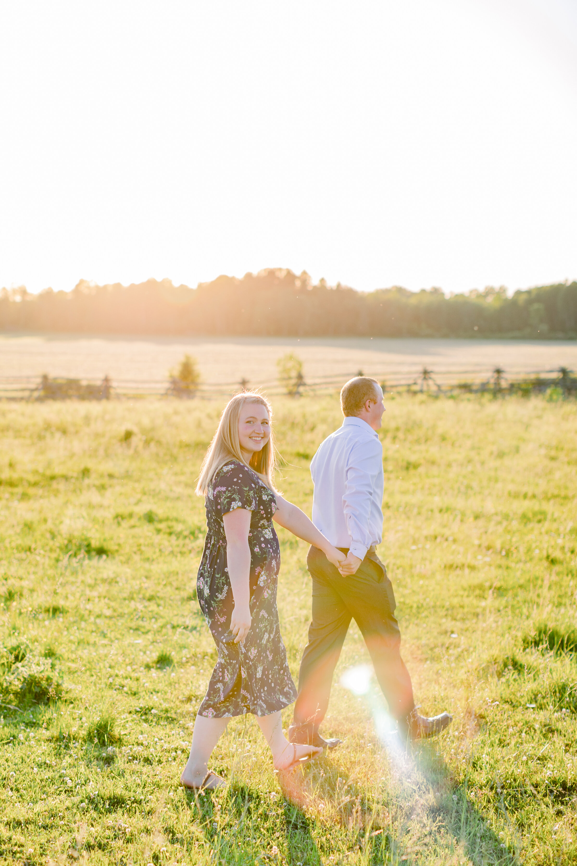  A couple walk through the glowing field in a golden hour engagement photo shoot by professional photographer Chelsea Mason. Couple walking pose inspiration ideas and goals summer engagement session inspiration ideas and goals outdoor engagement sess