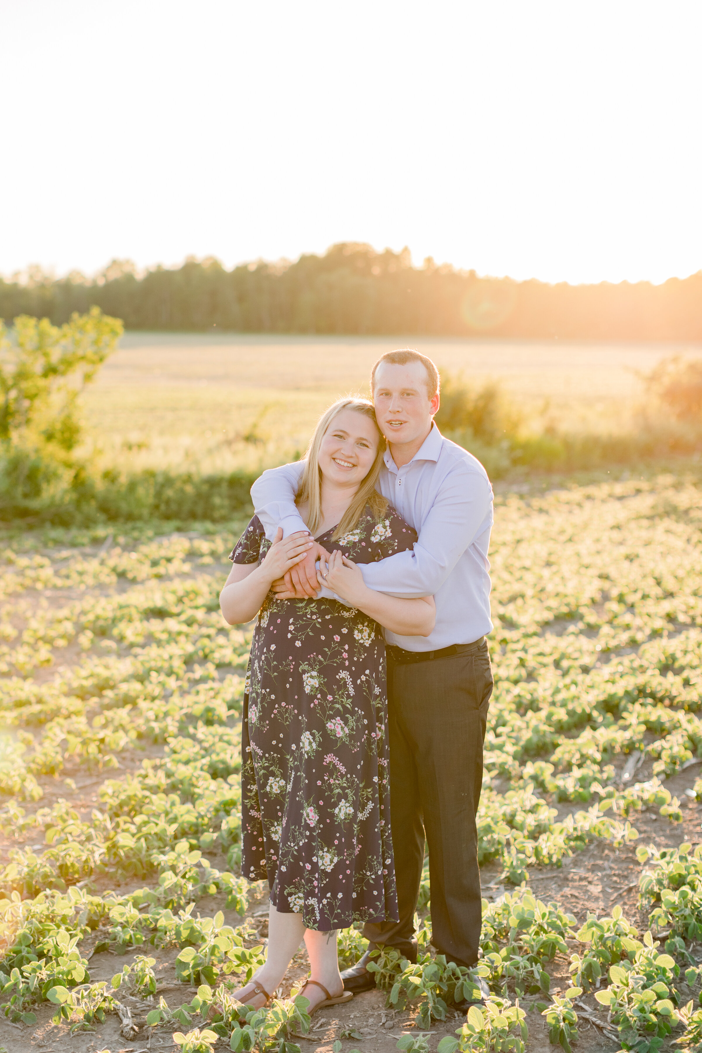  A couple stands together in an open field in a gorgeous country themed engagement session by Chelsea Mason Photography. Engagement session in the country farm styled engagement session engagement goals country goals couple pose inspiration golden ho