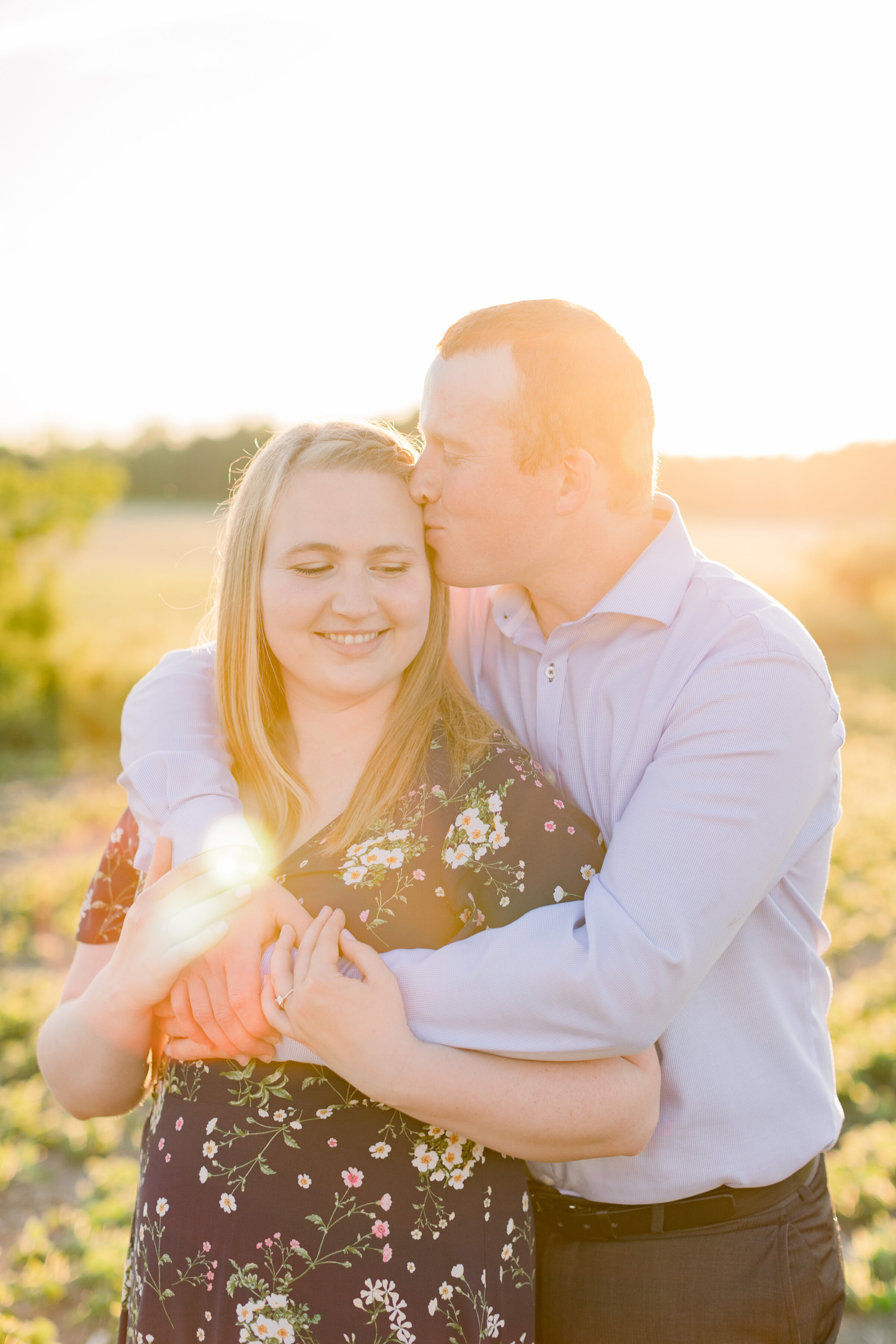  The groom kisses his soon to be wife’s head in a bright and beautiful engagement session on the farm. Engagement session inspiration couple pose inspiration couple goals photography goals outdoor session inspiration  semi formal client attire inspir