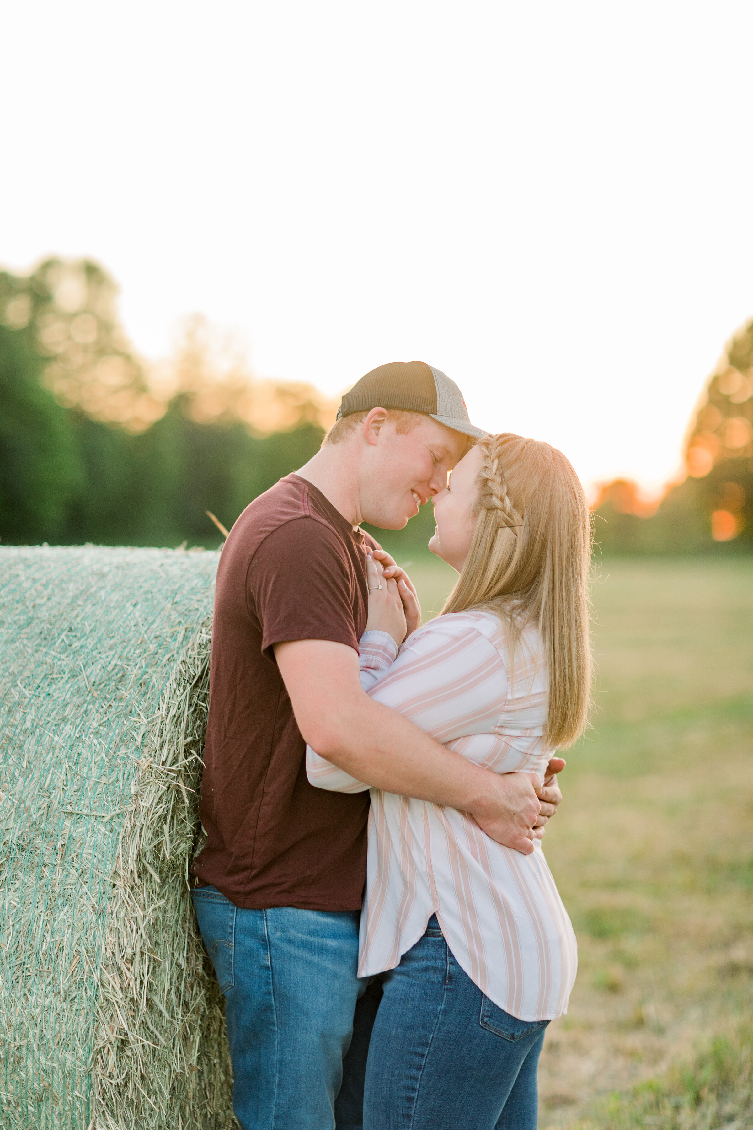  The groom goes in for a kiss in a beautiful farm themed engagement session at golden hour. Romantic couple pose inspiration outdoor photo shoot inspiration ideas and goals Chelsea Mason Photography professional engagement photographer standing coupl