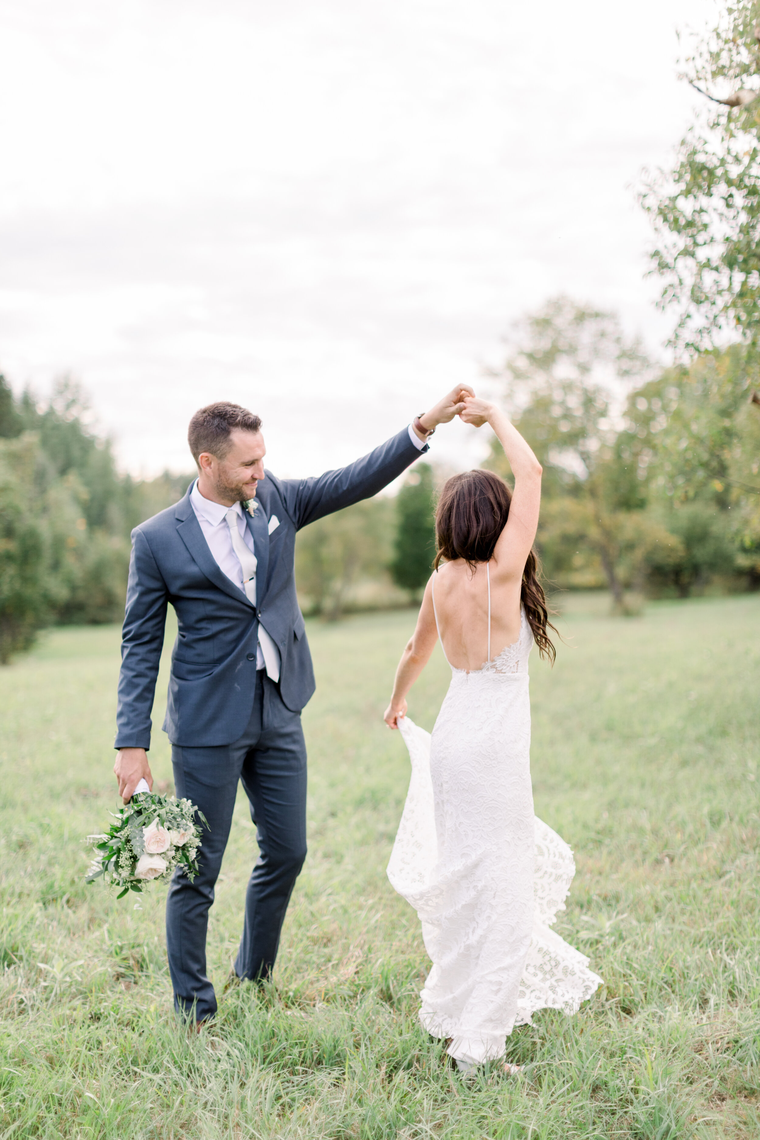  The bride and groom celebrate their marriage with a little dance in Kinmount, Ontario captured by Chelsea Mason Photography. Bride and groom first dance wedding pics inspo lovers white wedding dress lace blue gray suit wedding attire ottawa wedding 