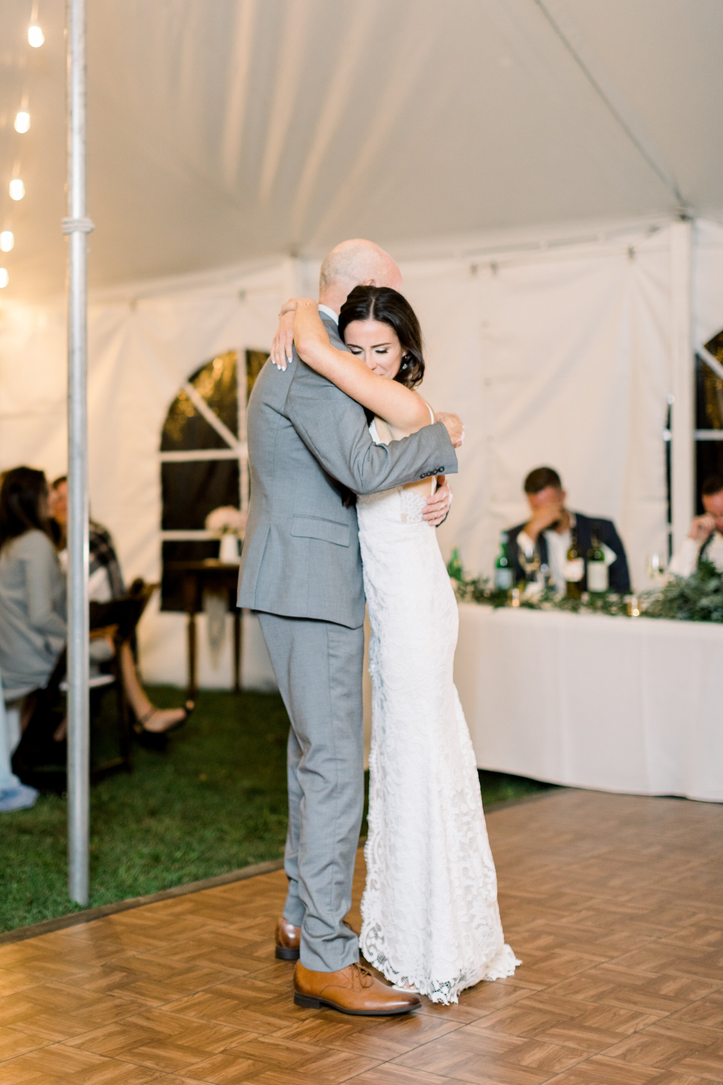  The bride and her father share a dance on the dance floor in this backyard wedding in Ottawa, Ontario captured by Chelsea Mason Photography. Father daughter dance wedding night dance floor white lace wedding dress details happy moment candid kinmoun