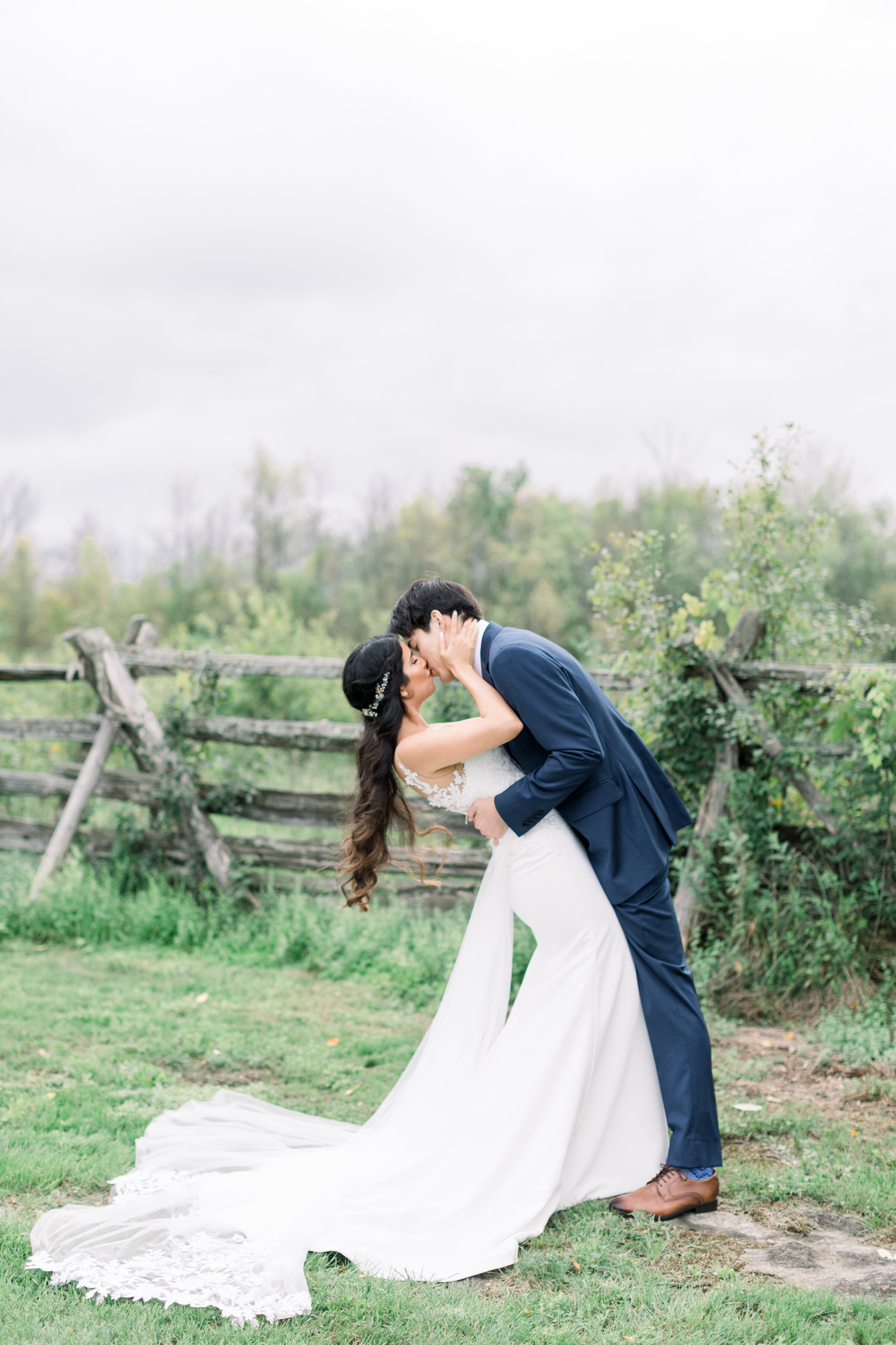  The bride and groom share a romantic kiss on the rustic grounds of Stonefields Estates in Ottawa by professional Ottawa wedding photographer Chelsea Mason Photography. Couple kissing pose inspiration ideas and goals wedding day photo shoot inspirati