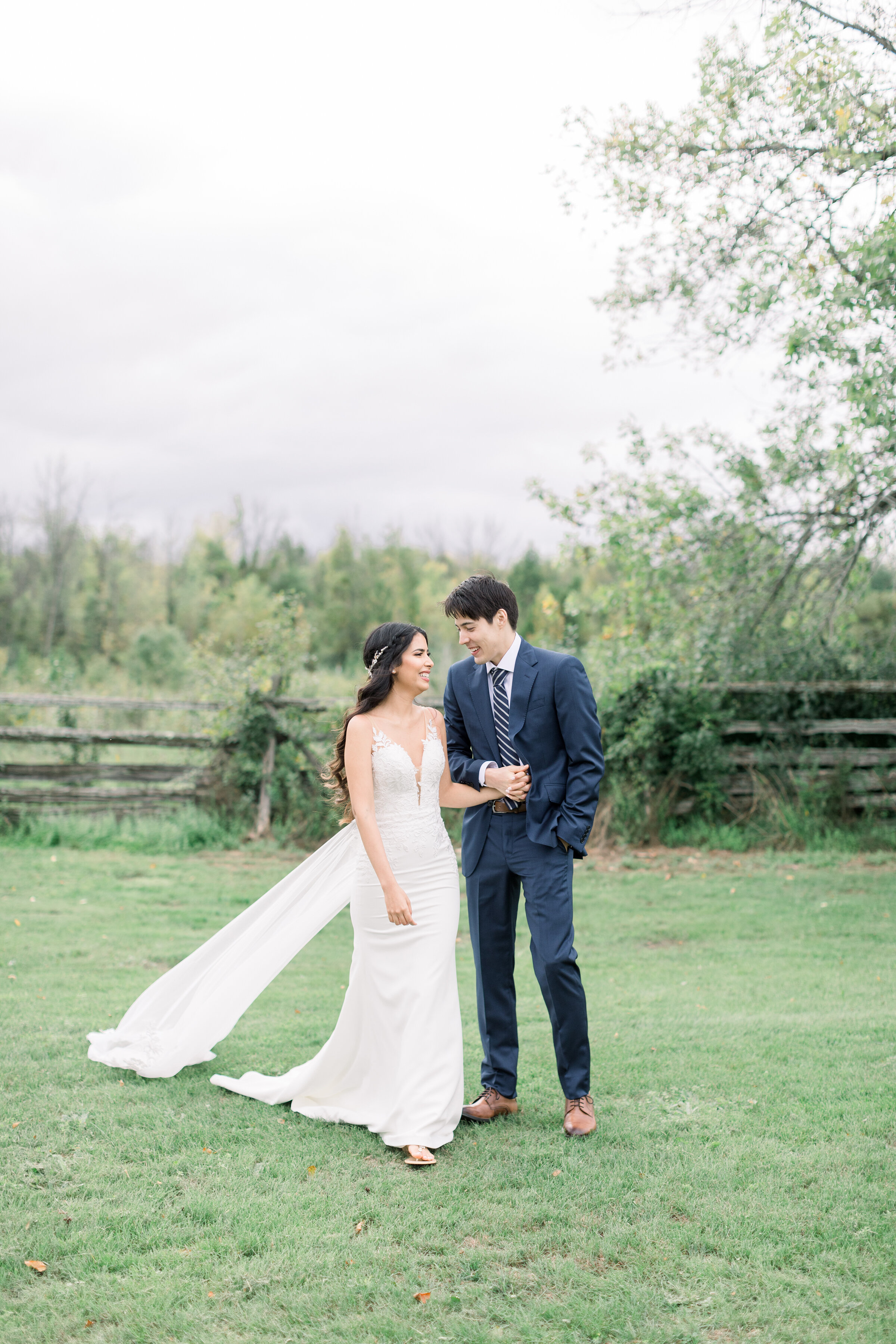  A happy couple walk across the grounds of Carleton Place at Stonefields Estates in Ottawa in a beautiful wedding styled photo shoot by Chelsea Mason Photography. Wedding day inspiration ideas and goals walking couple pose inspiration ideas and goals