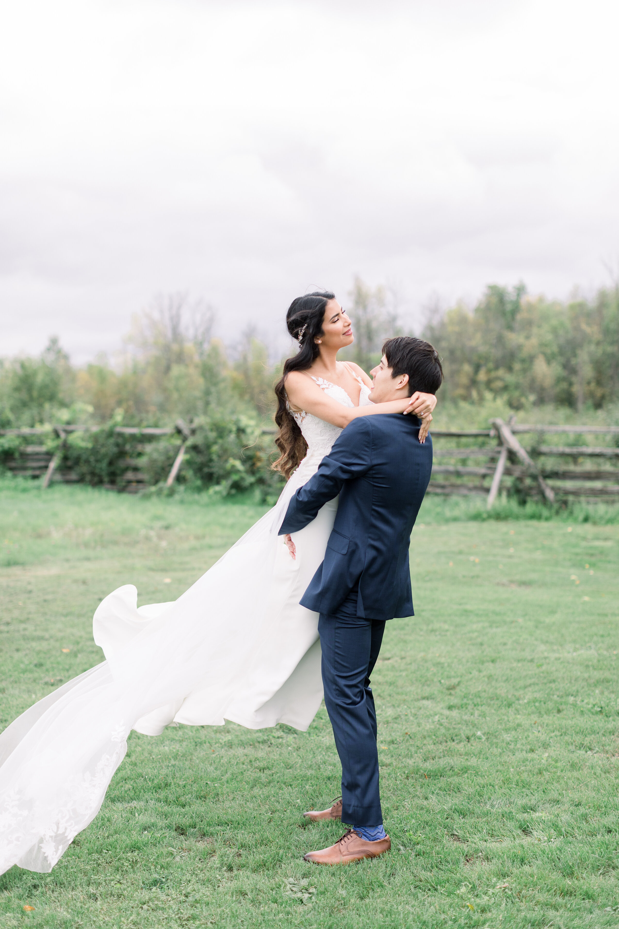 A handsome groom lifts his beautiful bride on the grounds of Stonefields Estates, Carleton Place, Ottawa in a before the wedding styled photo shoot by Chelsea Mason Photography. Couple pose inspiration ideas and goals bridal aesthetic inspiration id