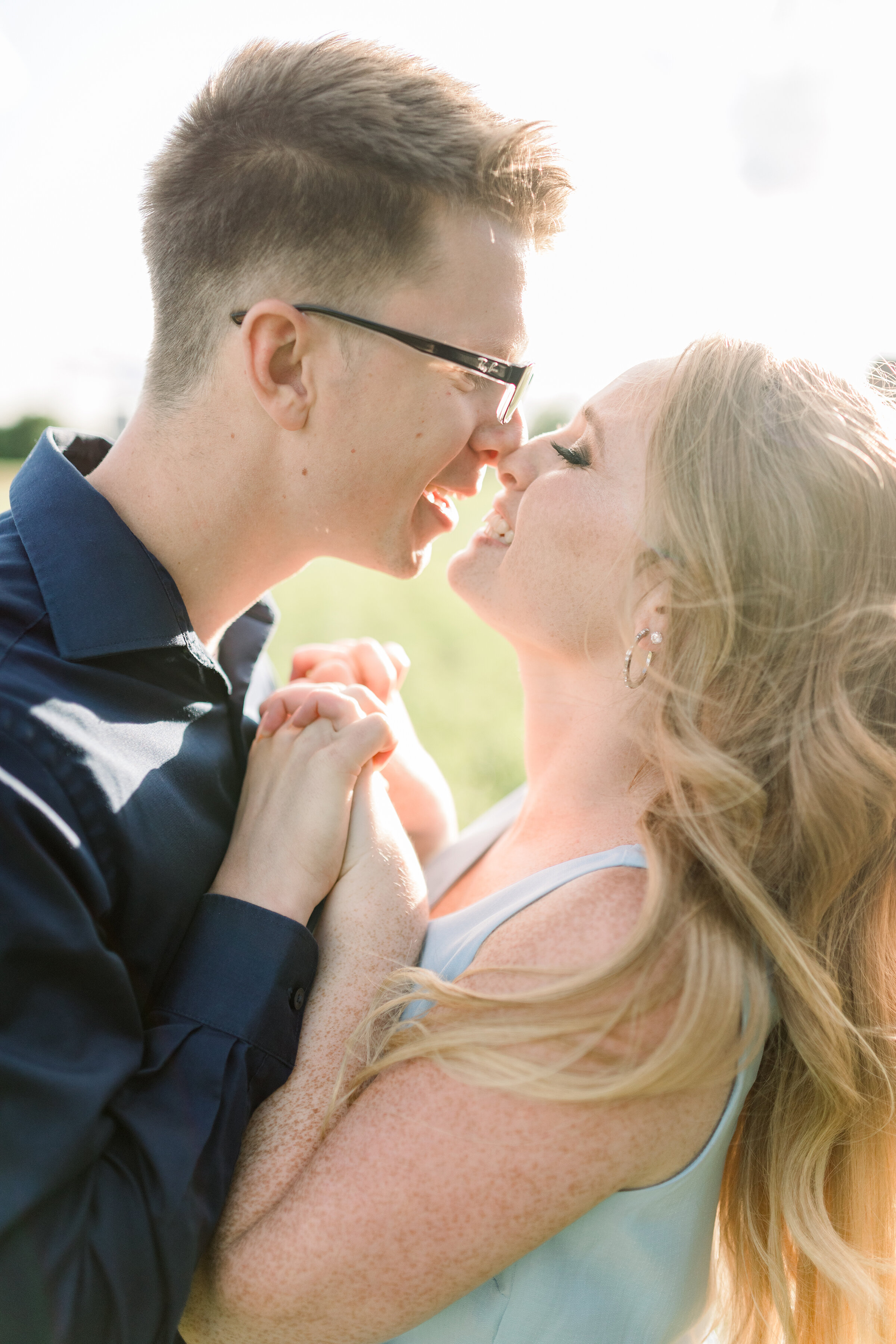  Soon to be husband and wife go in for a kiss in a bright and airy engagement styled photo shoot in Dominion Arboretum, Ottawa. Professional Ottawa photographer Chelsea Mason Photography couple goals couple pose inspiration ideas and goals summer eng