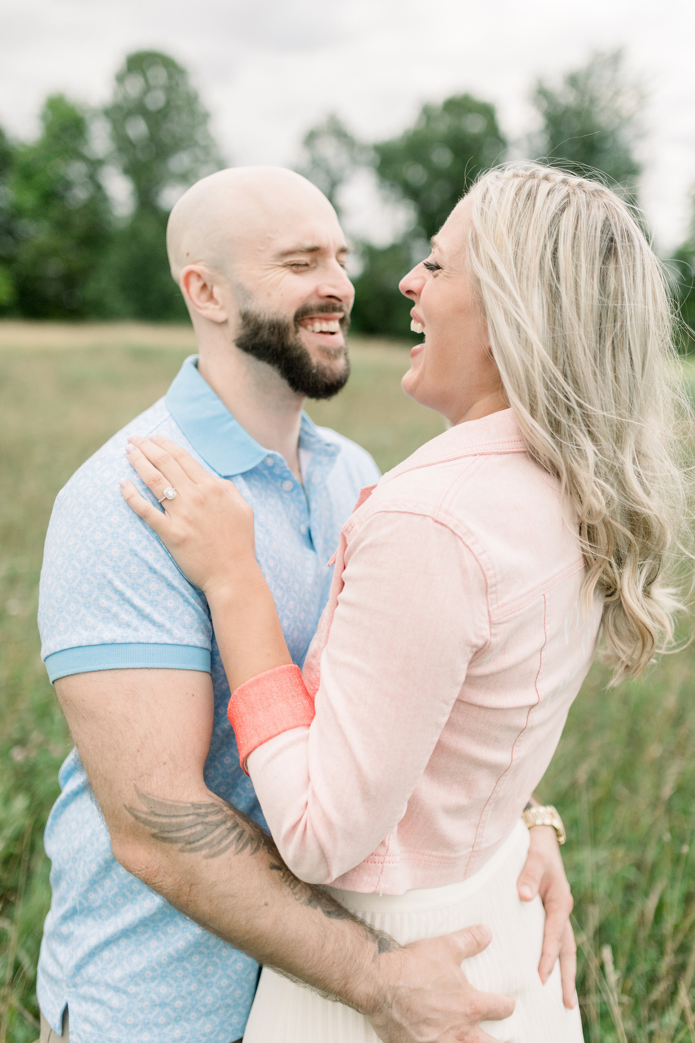  A happy couple laugh with each other in a fun filled engagement session by Chelsea Mason Photography in Ashton, Ontario. Couple pose inspiration ideas and goals couple goals outdoor engagement session location inspiration ideas and goals summer enga