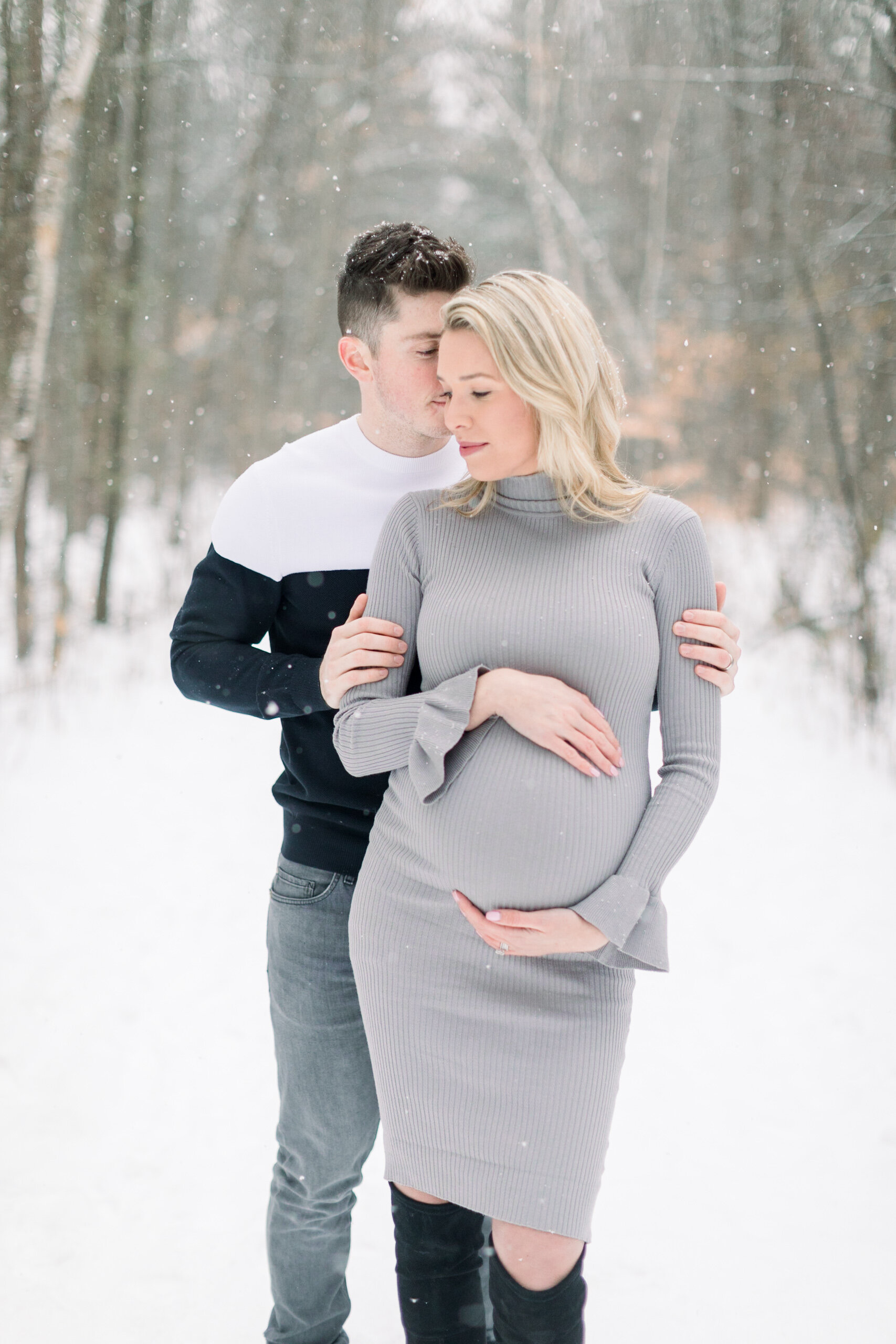  A husband and wife share a sweet moment as she cradles her belly in a beautiful Ottawa winter maternity session by Chelsea Mason Photography. Winter goals maternity session goals ideas and inspiration couple goals couple pose inspiration ideas and g