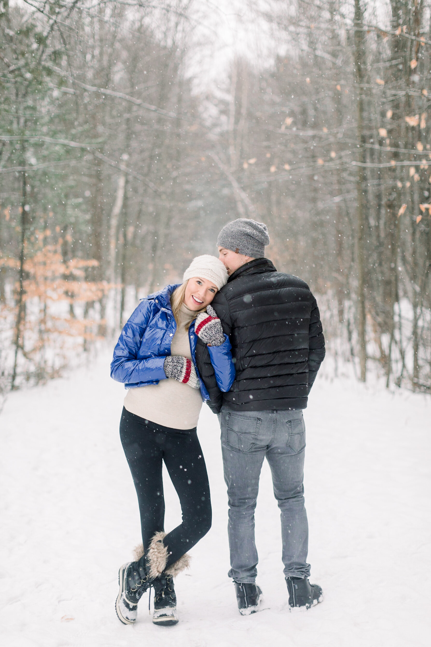  A glowing wife rests her head on her husbands shoulder in a beautiful winter maternity photo shoot on the Pinhey’s Trails in Ottawa. Professional maternity photographer Chelsea Mason Photography couple goals couple pose inspiration ideas and goals c