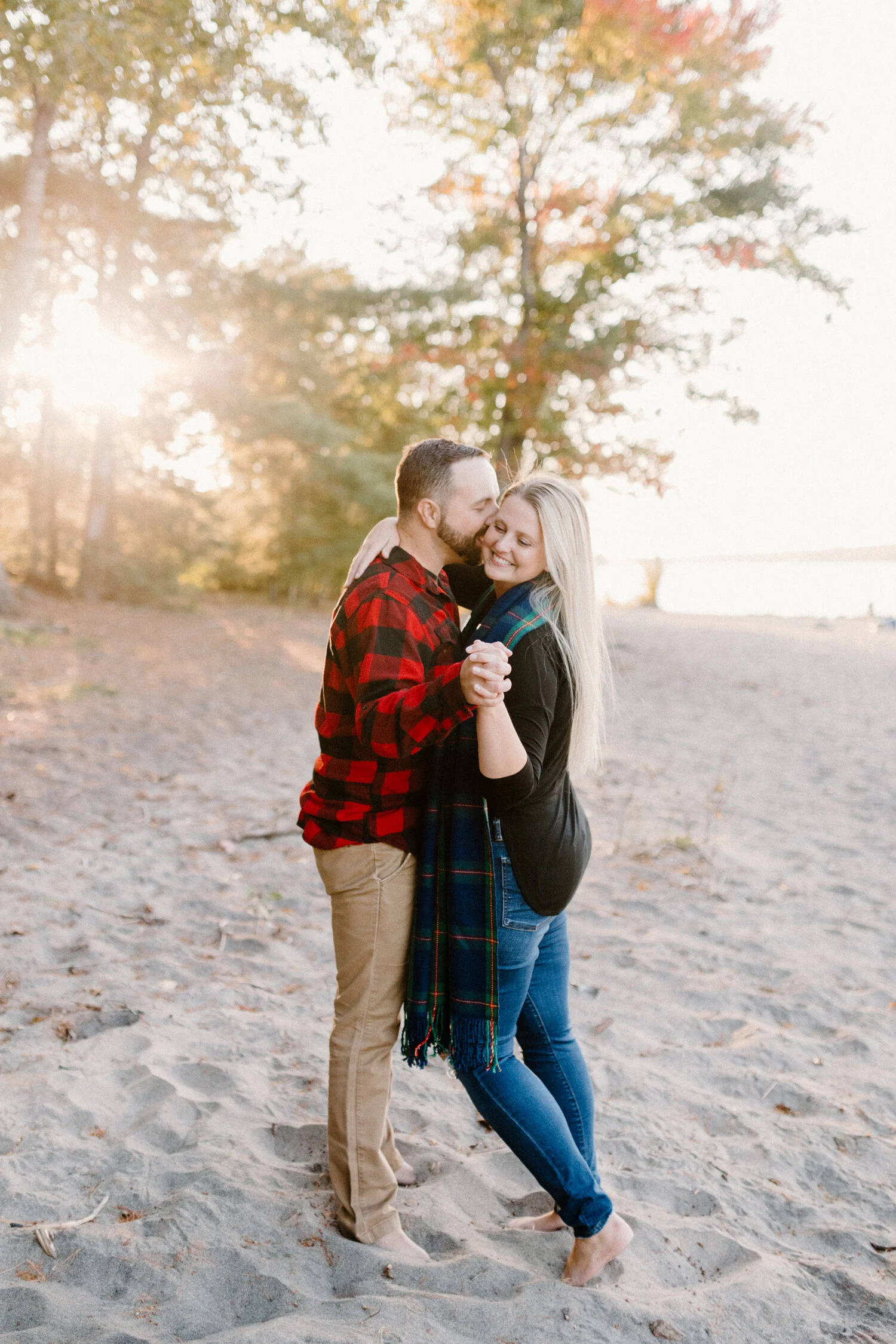  Chelsea Mason Photography captures a tender romantic moment between this engaged couple as this soon-to-be groom kisses his fiance’s cheek along the shore of Constance Bay Beach in Ottawa, Canada. Chilly beach engagement session ottawa canada engage