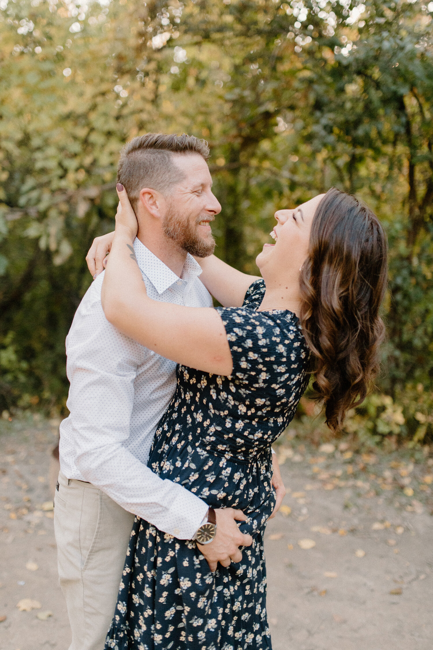  During this camping engagement session in Ontario, Canada, Chelsea Mason Photography captures this playful couple hugging and laughing. Laughing playful engagement session, ontario canada engagement photographer, formal engagement outfit inspiration