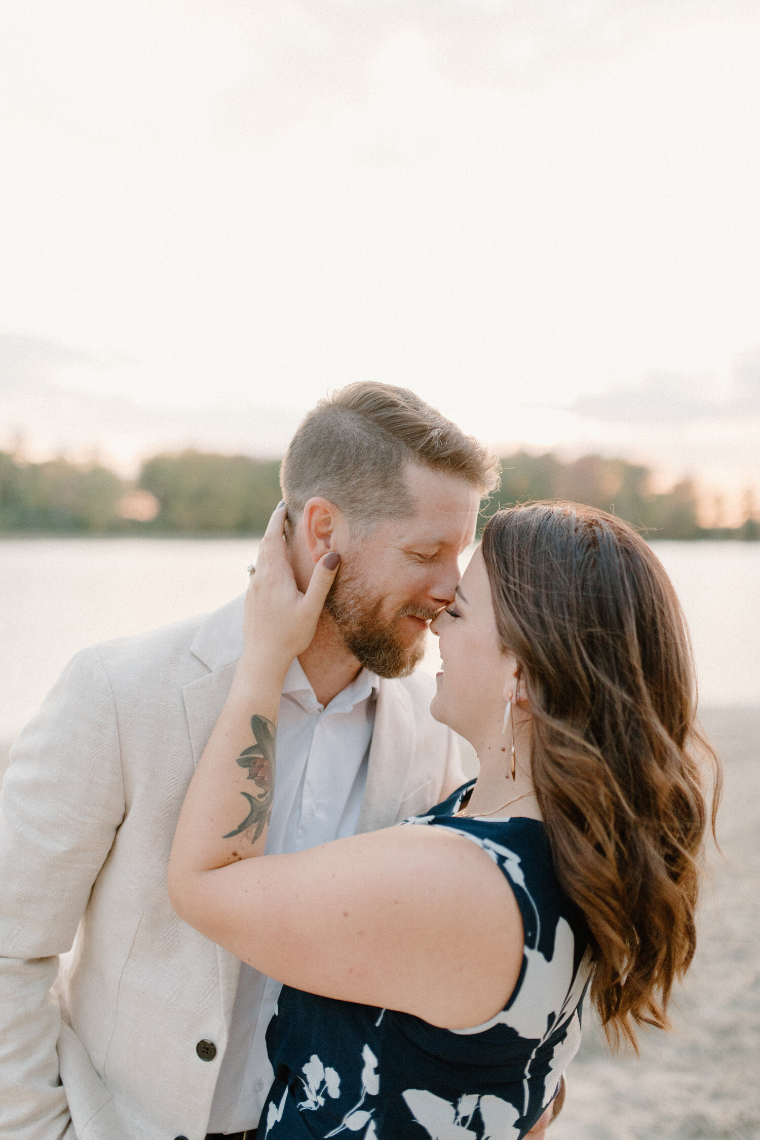  During this beach engagement session in Ontario, Canada, Chelsea Mason photography captures this soon-to-be bride and groom pressing their foreheads together and laughing. Playful beach engagement session, ontario canada photographer, formal engagem