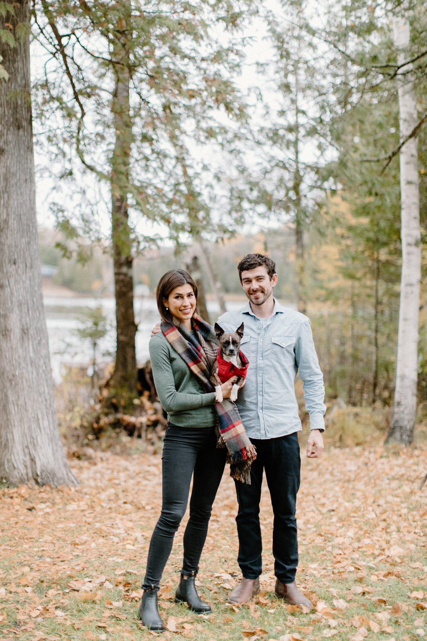  During this wooded Quebec, Canada engagement session, Chelsea Mason Photography captures this couple posing with their french bulldog. Quebec canada engagement photographer, french bulldog engagement session, autumn forrest quebec canada engagement 