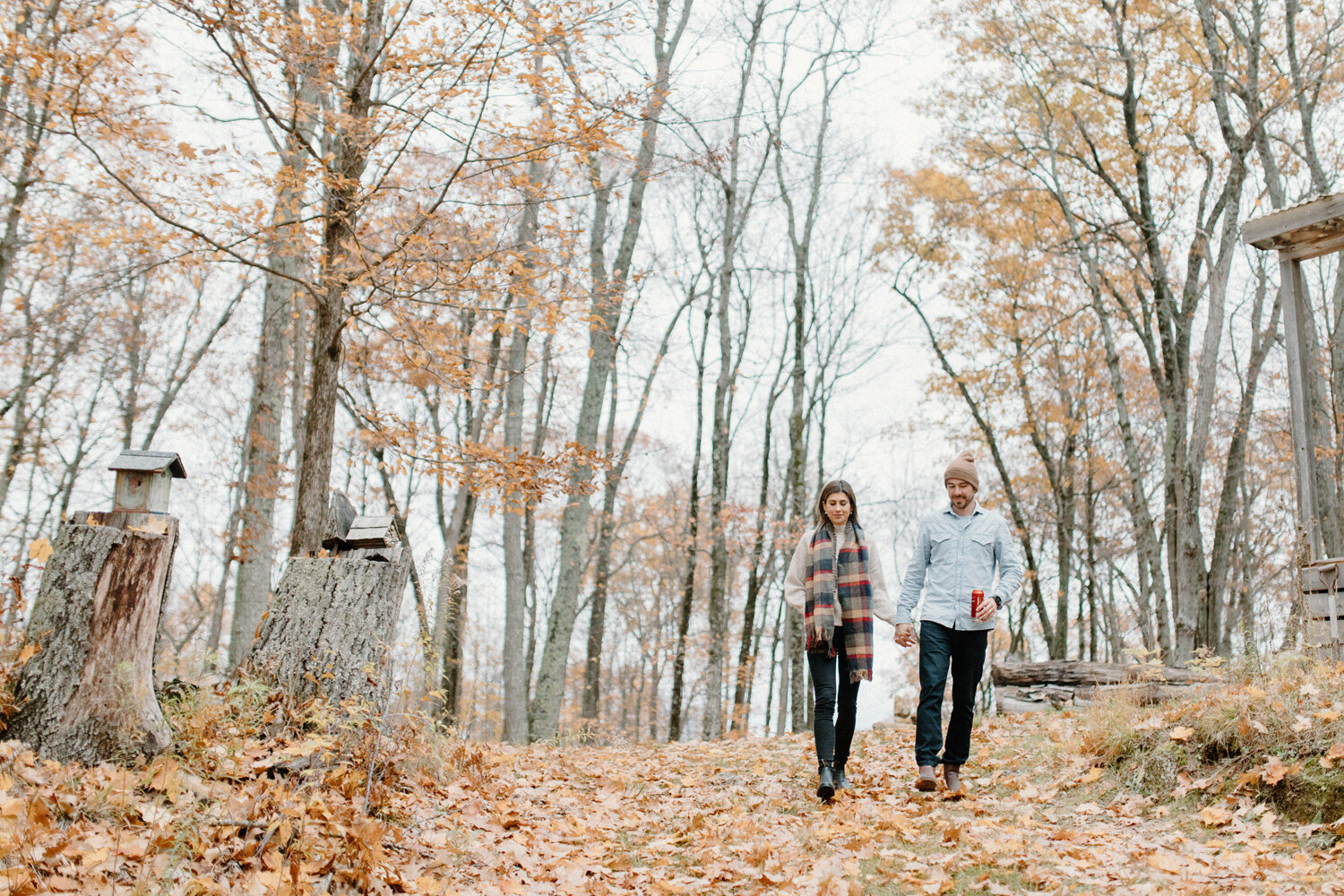 Ottawa, Canada engagement photographer, Chelsea Mason Photography captures this couple walking down a wooded hill while holding hands during this cottage engagement session. Cottage wooded engagement session, ottawa canada engagement photographer, a