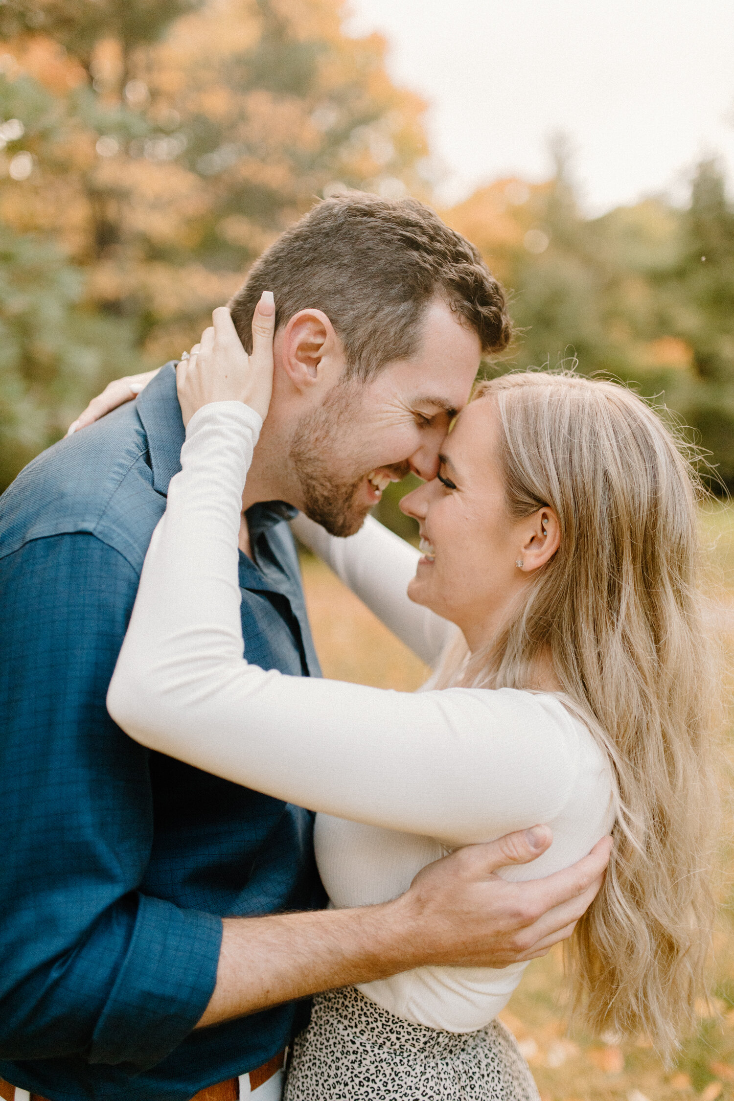  During this playful engagement session, Quebec, Canada photographer, Chelsea Mason Photography captures this couple laughing and pressing their foreheads together during an embrace. playful couple embrace, happy laughing couple engagement session, m