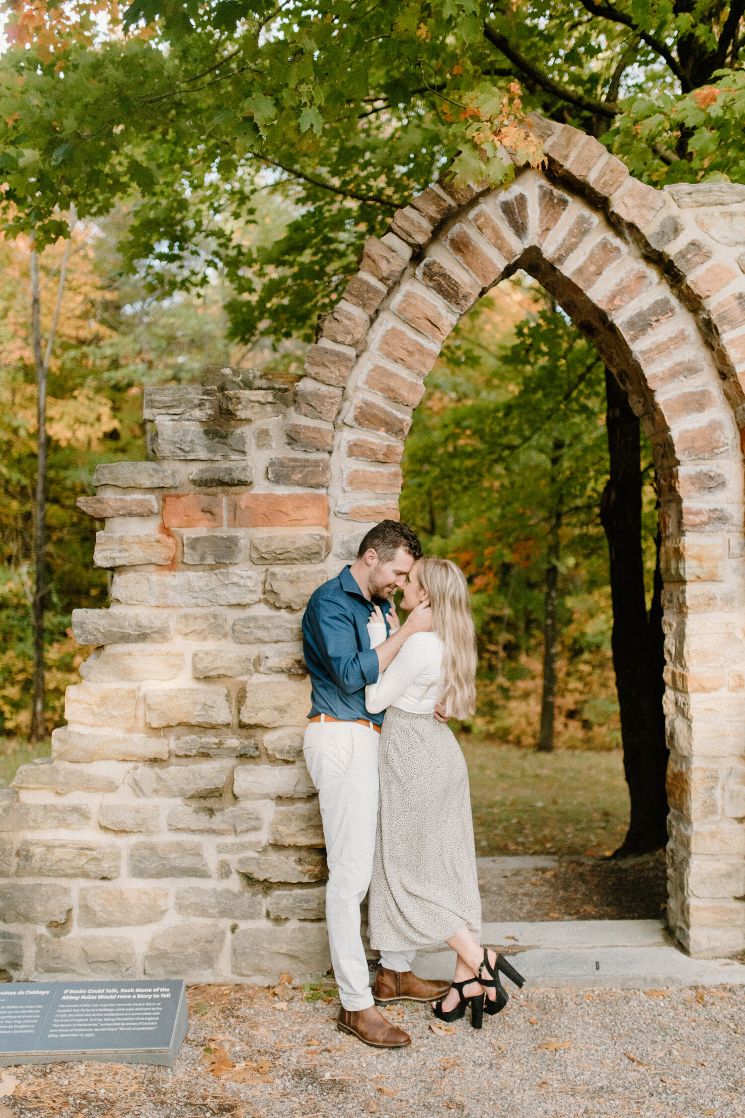  Posed against a beautiful brick archway, Quebec, Canada photographer, Chelsea Mason Photography captures this bride and groom kissing during their engagement session. brick garden archway, romantic quebec canada engagement photographer, neutral enga
