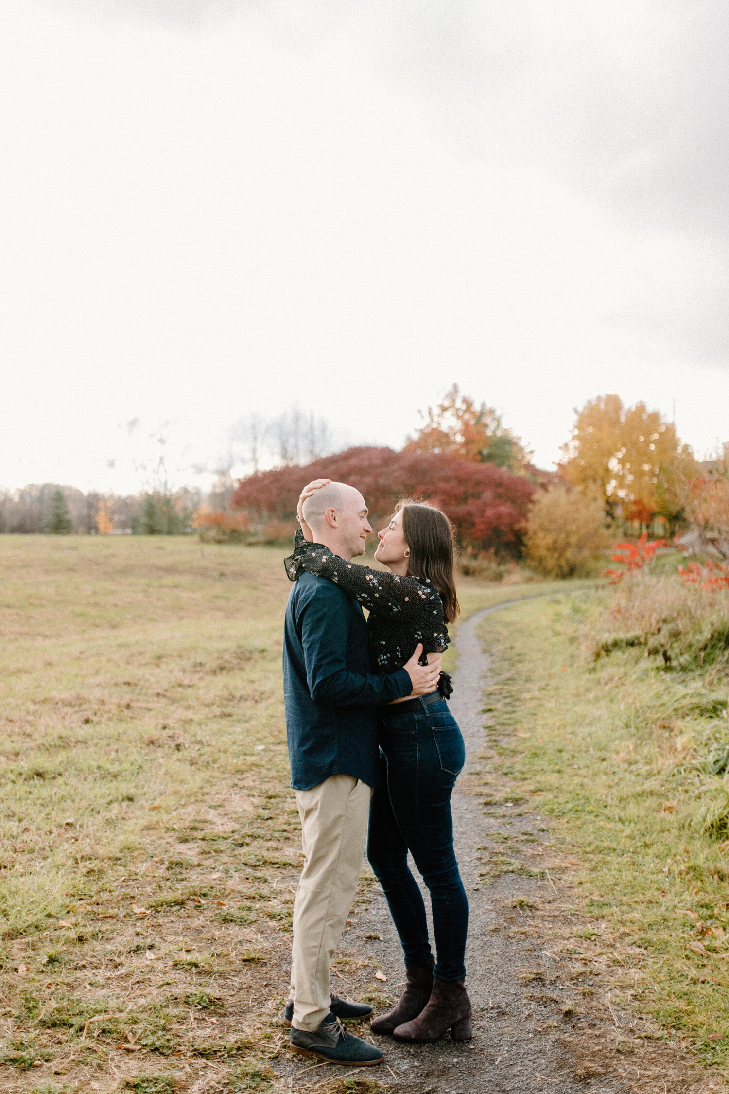  During this autumn engagement session in Ottawa, Canada, Chelsea Mason Photography captures a tender moment between this couple as they wrap their arms around one another. black and denim colored engagement outfit colors, engagement session, autumn 