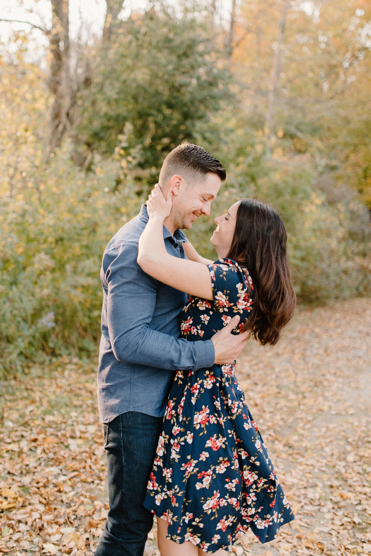  During their autumn engagement session in Brockville, Ontario, this engaged woman wraps her arms around her fiance’s neck while smiling into his eyes during their engagement session with Chelsea Mason Photography. womens navy floral high low cotton 
