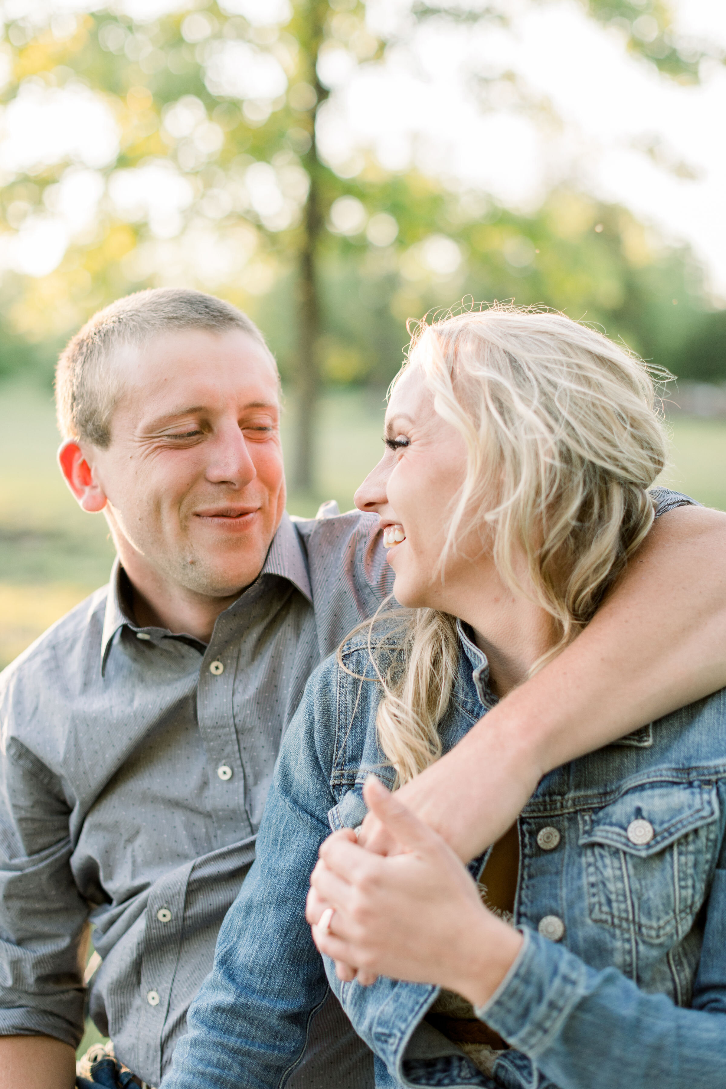  Ottawa, Canada photographer, Chelsea Mason photography captures this engaged couple smiling playfully with one another as this soon-to-be groom wraps his arms around his fiancé. couples posing Ottawa engagement photographer #ChelseaMasonPhotography 