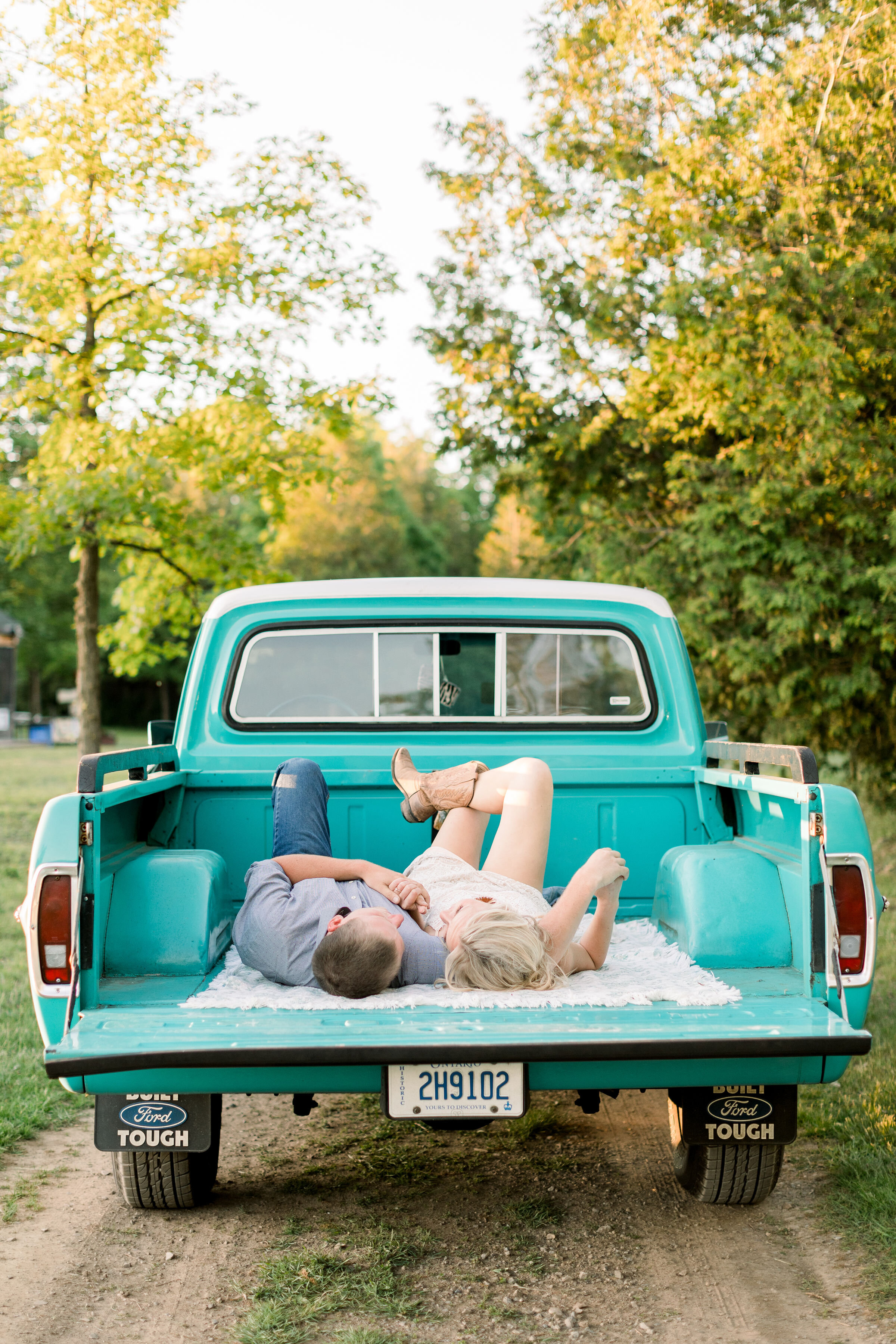 Ottawa, Canada photographer, Chelsea Mason photography captures this engaged couple lying in the bed of this vintage Ford pickup truck during this southern-styled shoot. engagement photographer Ottawa Canada ford pickup truck prop #ChelseaMasonPhoto